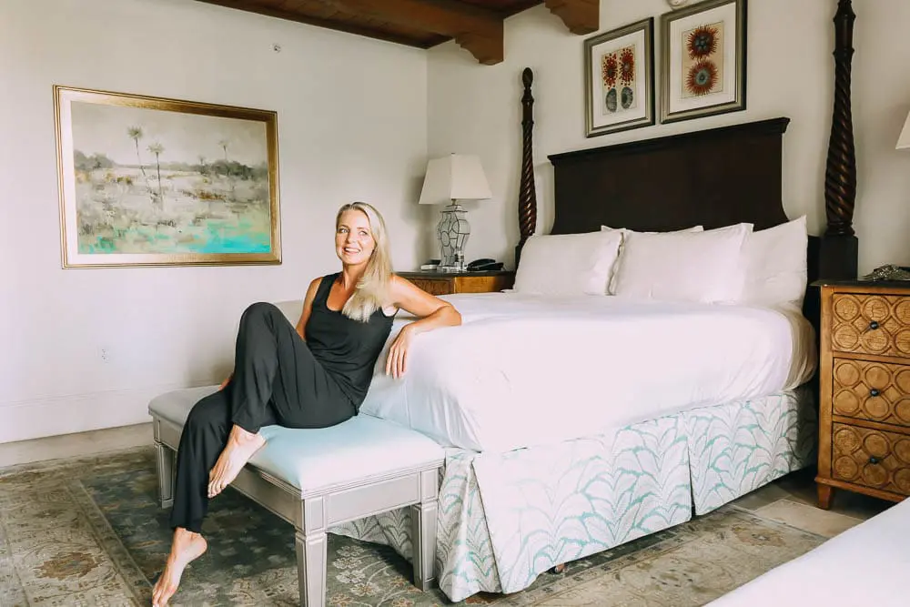 best pajamas, black luxe jersey sleeveless top and cropped pants pajamas set by Barefoot Dreams on blonde woman