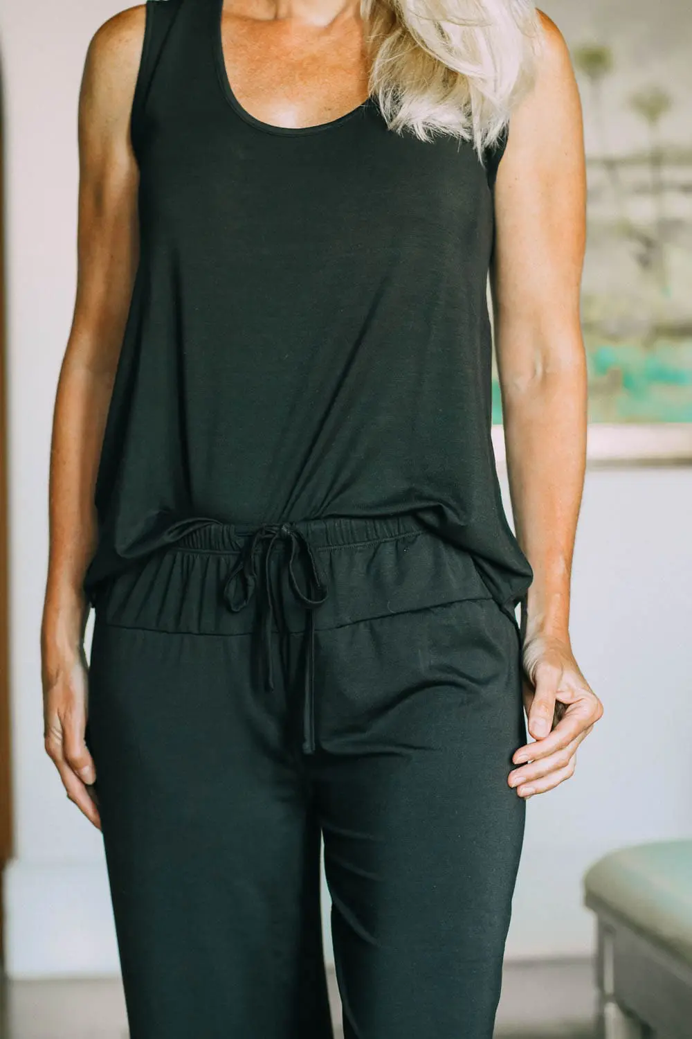 best pajamas, black luxe jersey sleeveless top and cropped pants pajamas set by Barefoot Dreams on blonde woman