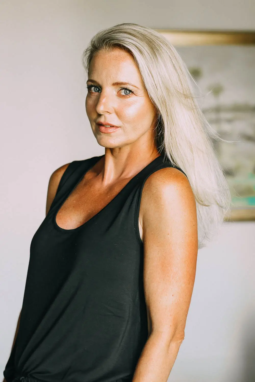 best pajamas, black luxe jersey sleeveless top and cropped pants pajamas set by Barefoot Dreams on blonde woman