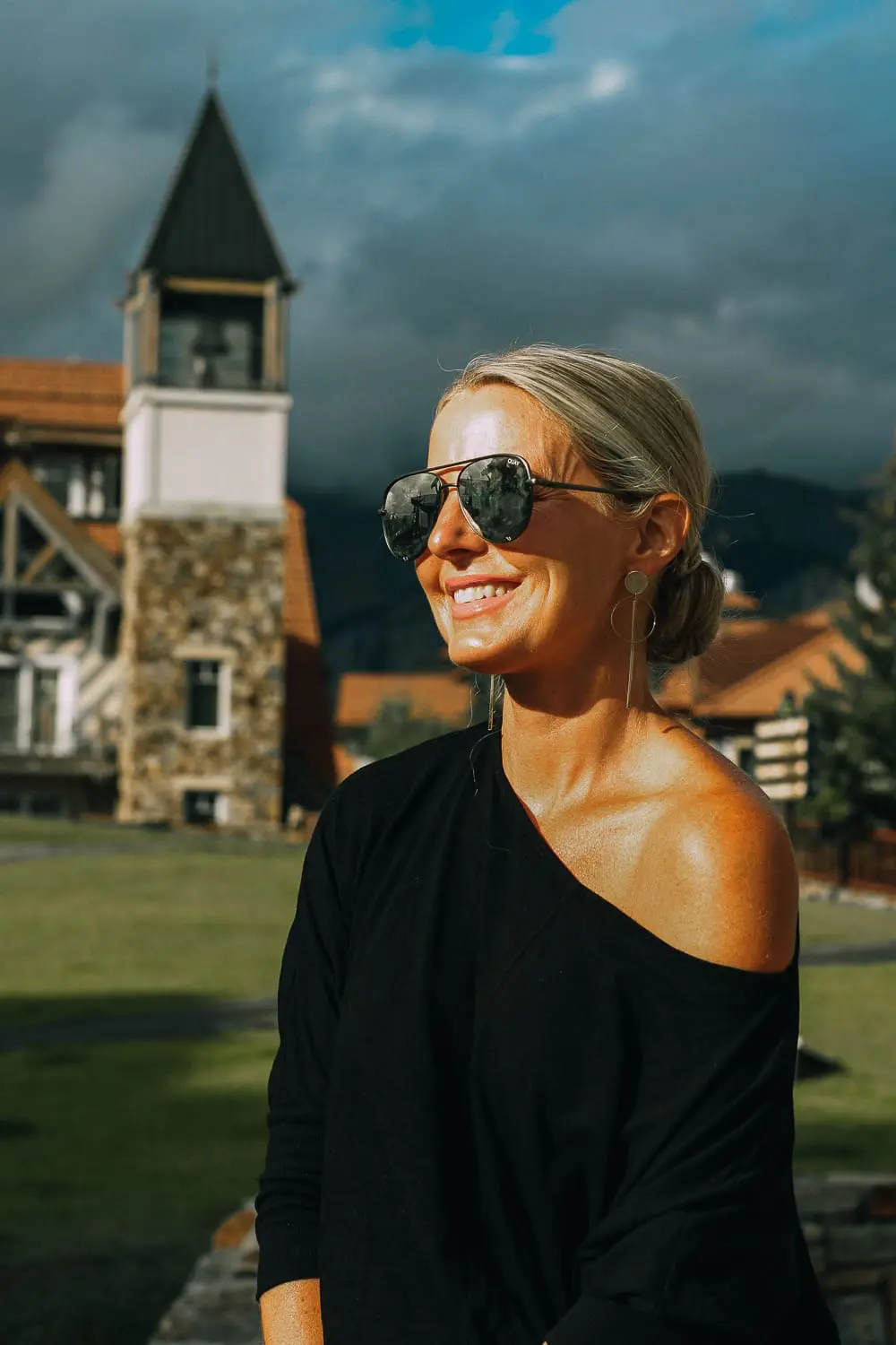 Best Jeans for Curves by Not Your Daughter's Jeans or NYDJ paired with black of shoulder dolman top, Quay aviator sunglasses, gold earrings on fashion blogger over 40, Erin Busbee of busbee style