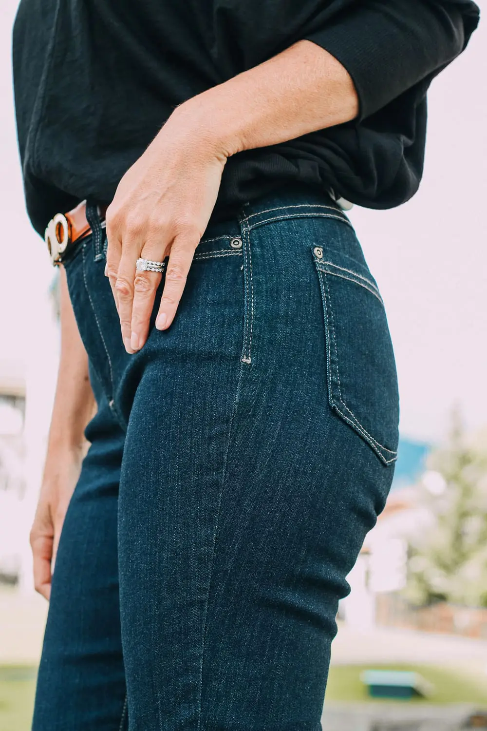 Best Jeans for Curves by Not Your Daughter's Jeans or NYDJ paired with black of shoulder dolman top, Quay aviator sunglasses, gold earrings on fashion blogger over 40, Erin Busbee of busbee style
