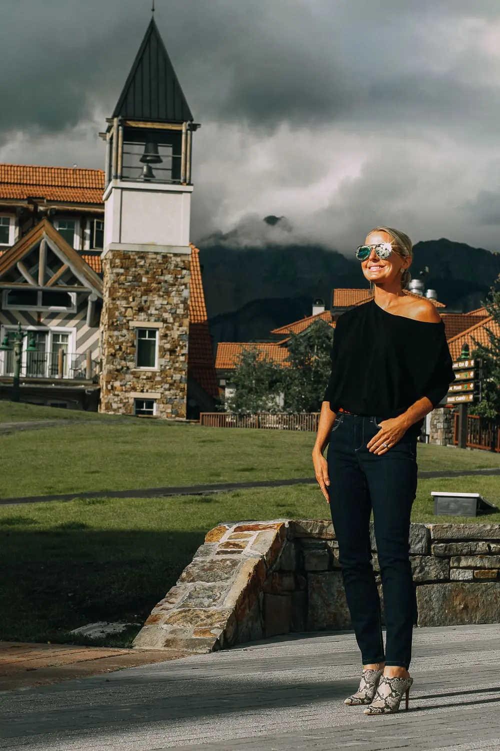 Best Jeans for Curves by Not Your Daughter's Jeans or NYDJ paired with black of shoulder dolman top, Quay aviator sunglasses, gold earrings on fashion blogger over 40, Erin Busbee of busbee style