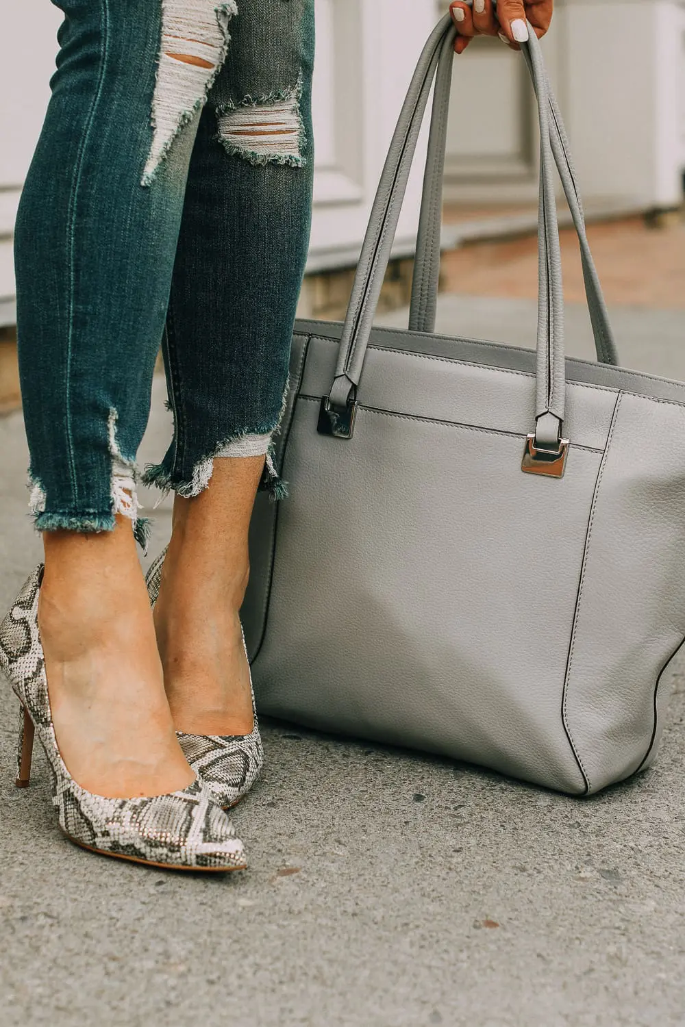 Vince camuto python print pumps paired with distressed skinny jeans by Express