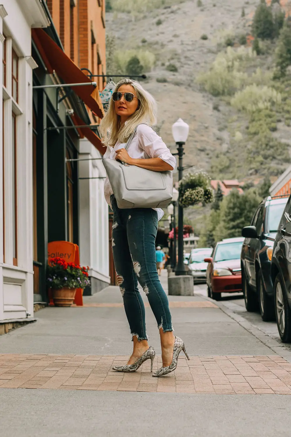 Vince camuto python print pumps paired with distressed skinny jeans by Express