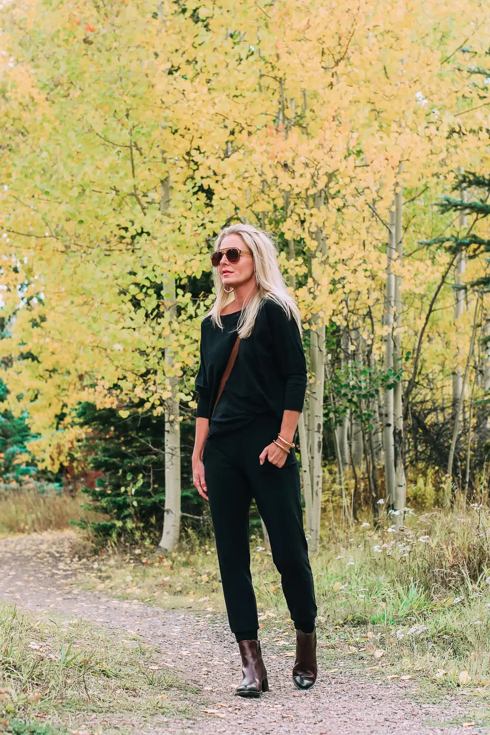ankle boots for walking in Bison brown with low block heel and comfort, cushion technology by ECCO on fashion blogger in black joggers by Norma Kamali and black off shoulder top with brown crossbody bag