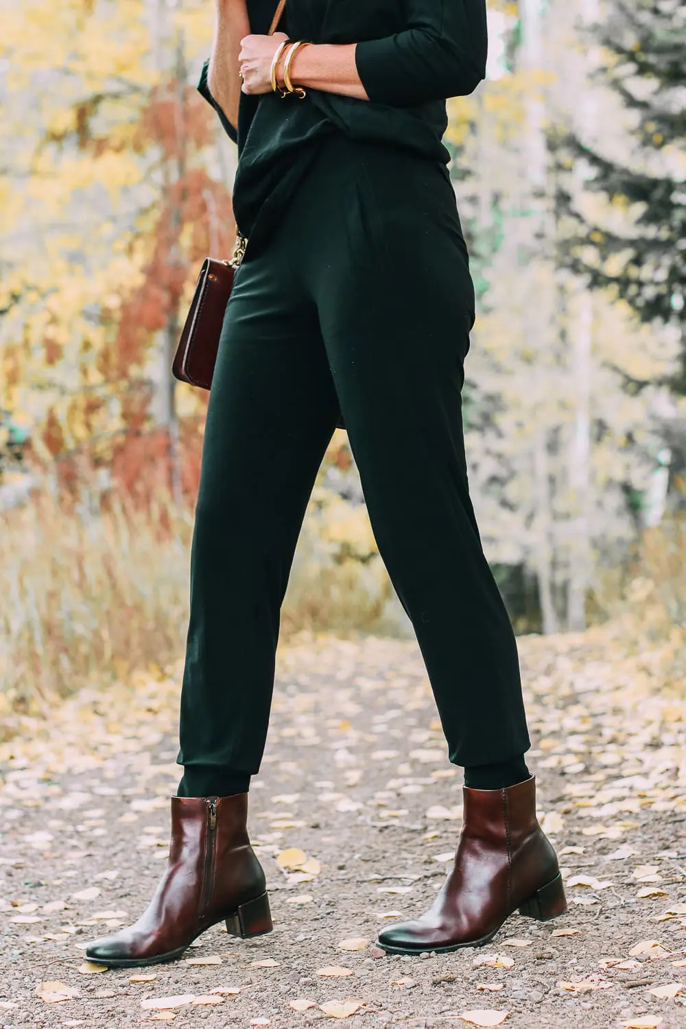 ankle boots for walking in Bison brown with low block heel and comfort, cushion technology by ECCO on fashion blogger in black joggers by Norma Kamali and black off shoulder top with brown crossbody bag