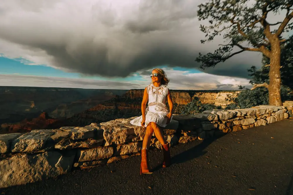 Grand Canyon Rim Trail featuring fashion blogger Erin Busbee of BusbeeStyle.com wearing white Shop Alexis dress and western Saint Laurent booties blogger Erin Busbee of BusbeeStyle.com wearing camel culottes, white turtleneck and a brown hat