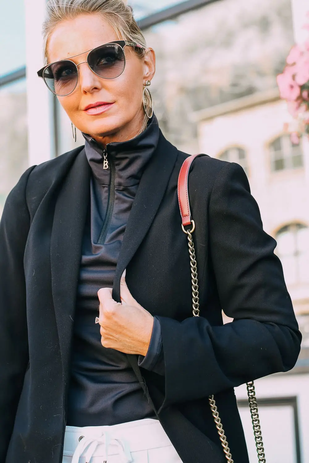 Henri Bendel quilted crossbody bag in burgundy with gold chain link detail paired with Pam & Gela striped pants, Bogner turtleneck and black blazer