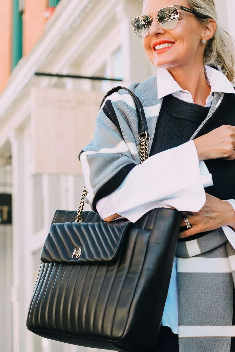 best work tote, quilted in black with chain link handles by Henri Bendel, paired with black jeans, patent leather sock booties, white Lafayette button down shirt and wrap