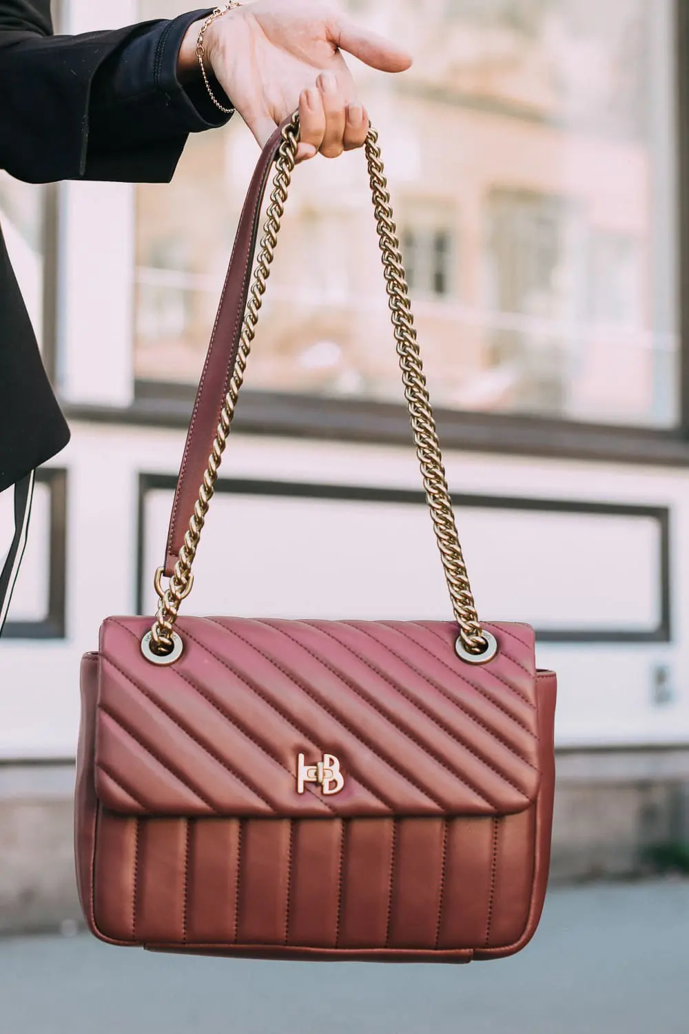 Henri Bendel quilted crossbody bag in burgundy with gold chain link detail