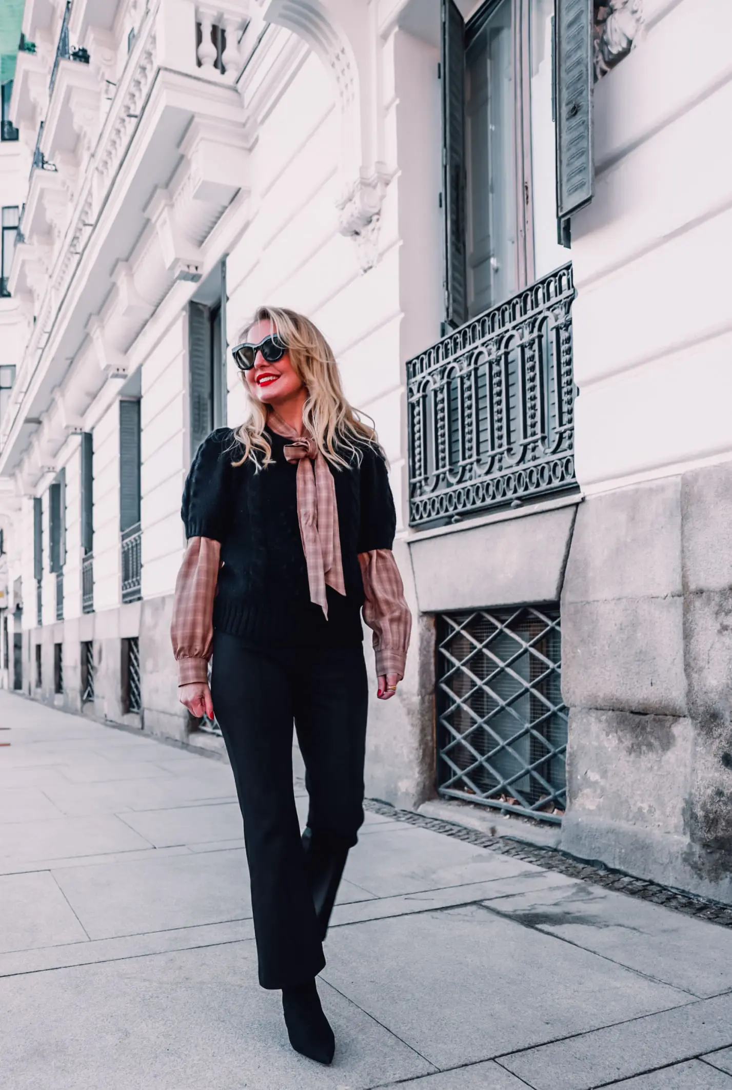 how to wear plaid, plaid, ways to wear plaid, plaid outfit, plaid over 40, erin busbee, & other stories check tie neck blouse, & other stories bobble and cable knit puff sleeve sweater, black & other stories flare pants, black schutz bette booties, madrid, spain