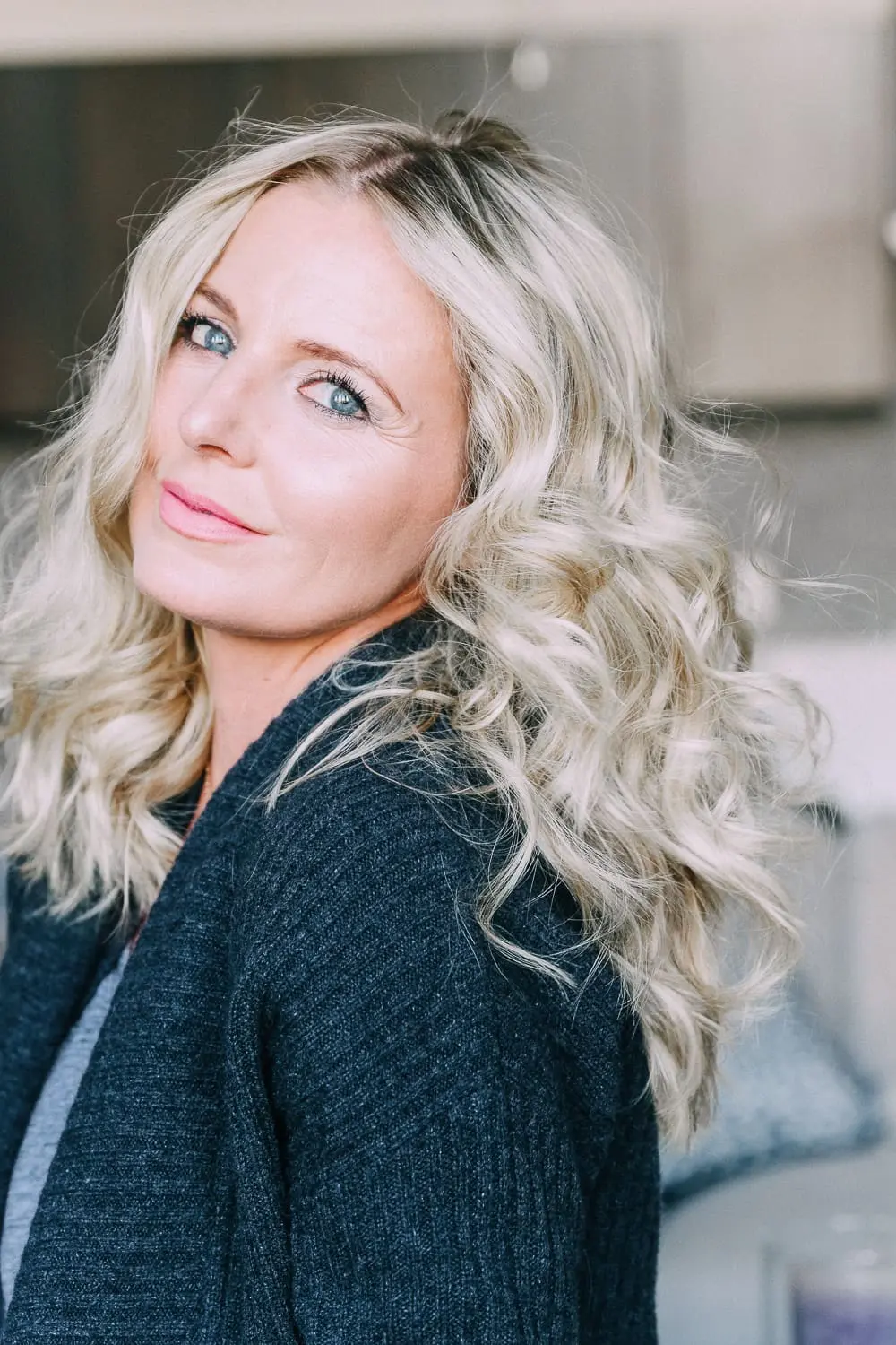 Curling your hair with a wand, step by step instructions by beauty blogger Erin Busbee with long blonde hair
