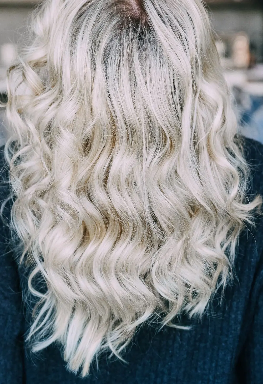 Curling your hair with a wand, step by step instructions by beauty blogger Erin Busbee with long blonde hair
