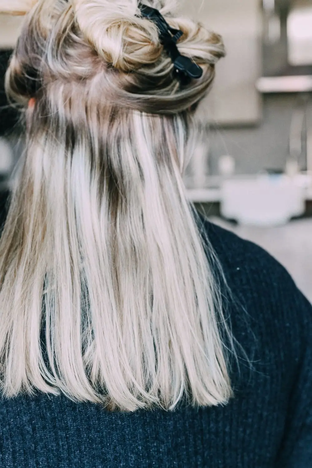 Curling your hair with a wand, step by step instructions by beauty blogger Erin Busbee with long blonde hair