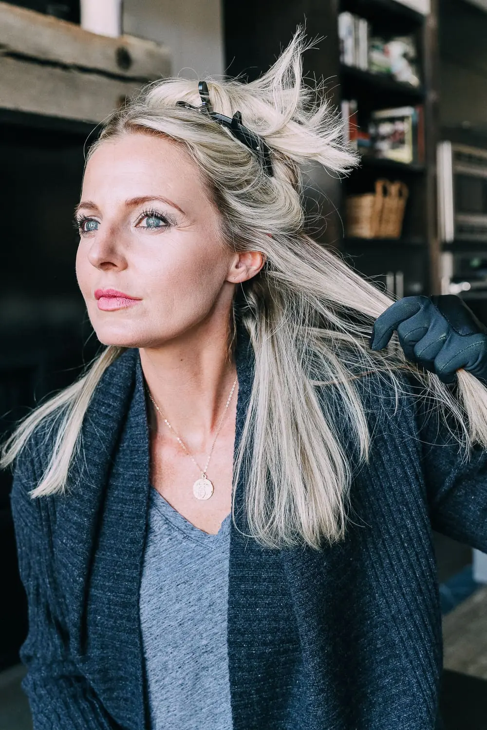 Curling your hair with a wand, step by step instructions by beauty blogger Erin Busbee with long blonde hair