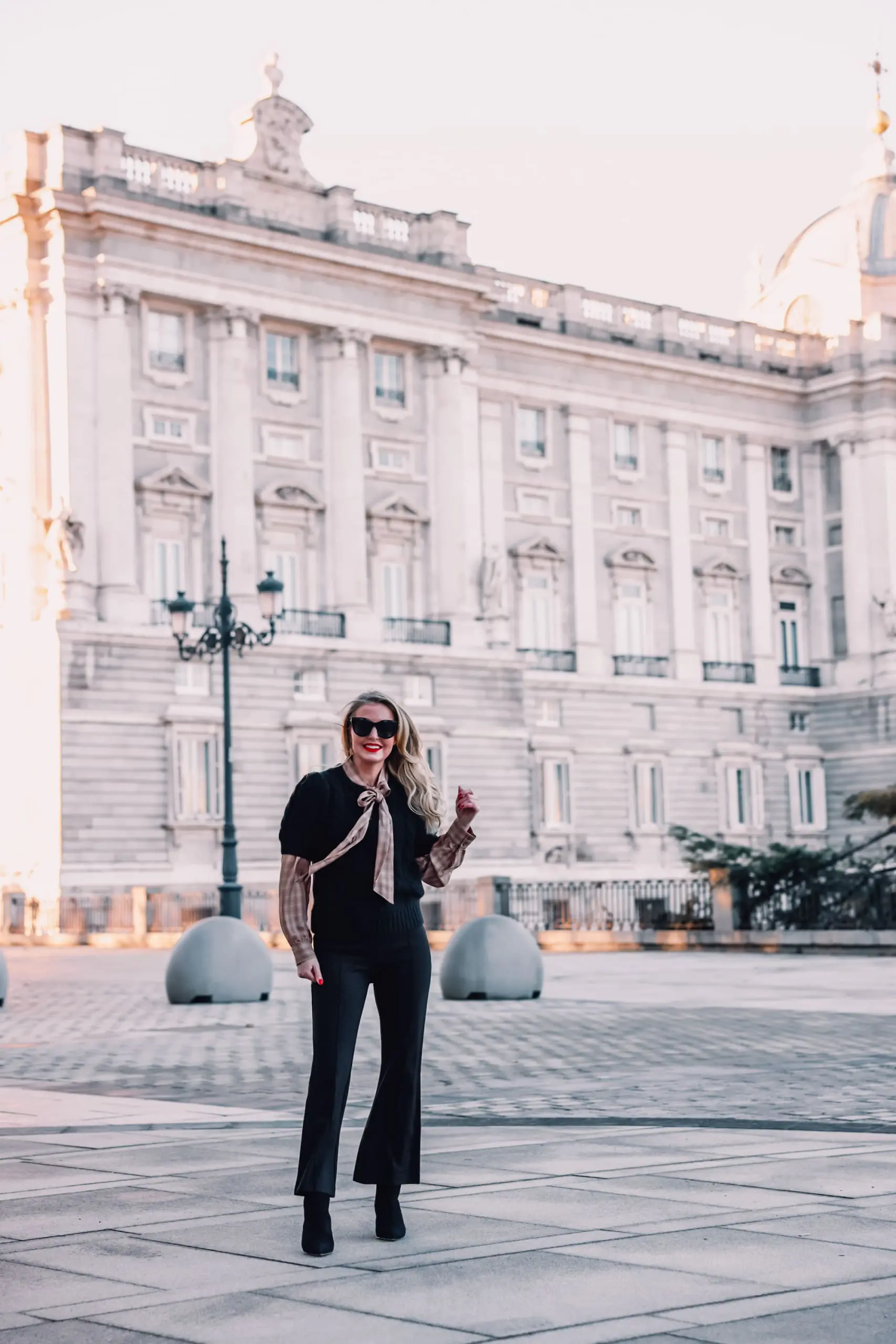 how to wear plaid, plaid, ways to wear plaid, plaid outfit, plaid over 40, erin busbee, & other stories check tie neck blouse, & other stories bobble and cable knit puff sleeve sweater, black & other stories flare pants, black schutz bette booties, madrid, spain