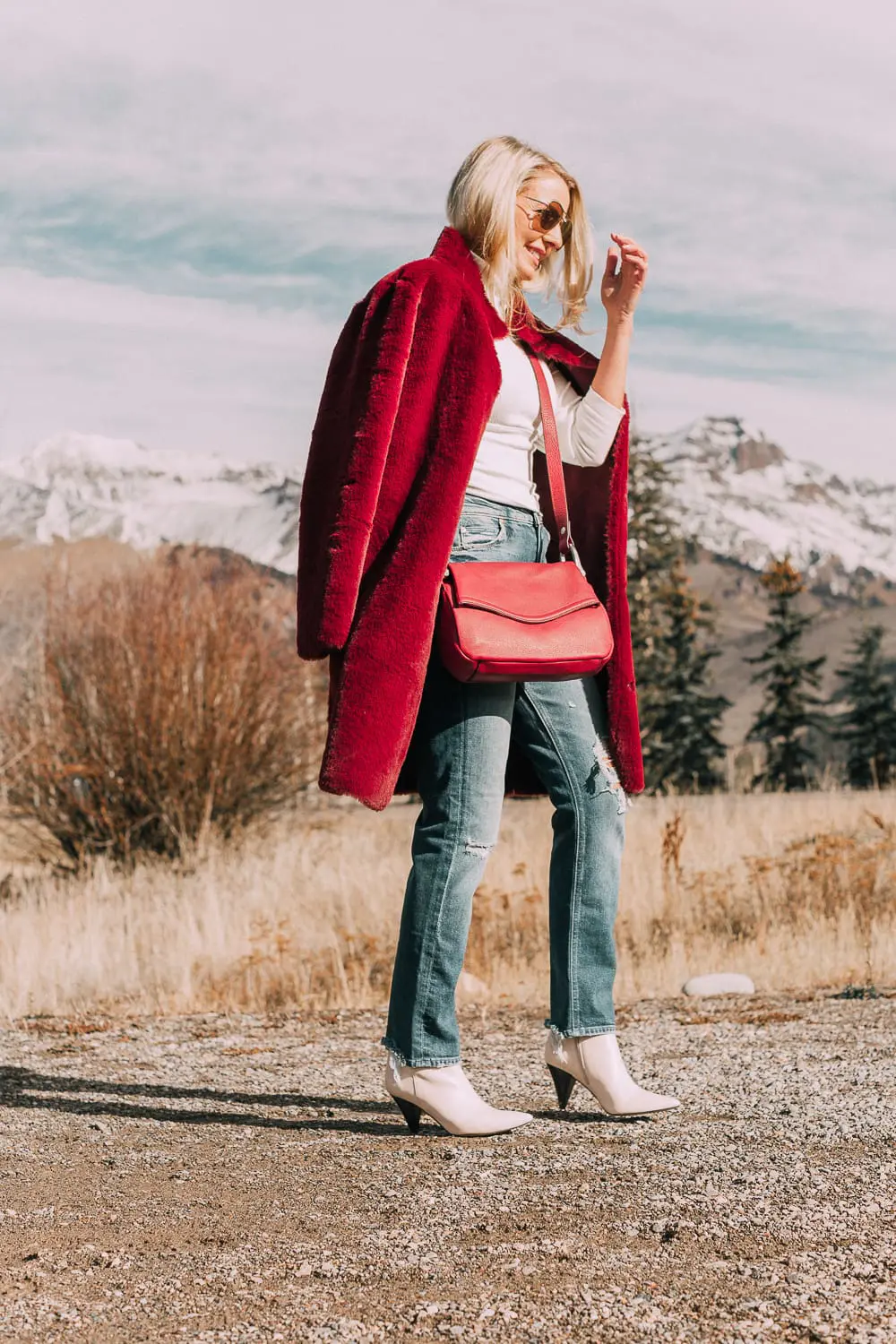 Bootie Trend, how to wear your ankle boots with dresses and jeans featuring white booties with a cone heel by Vince Camuto paired with a reversible faux fur coat, white turtleneck and Mother dazzler jeans