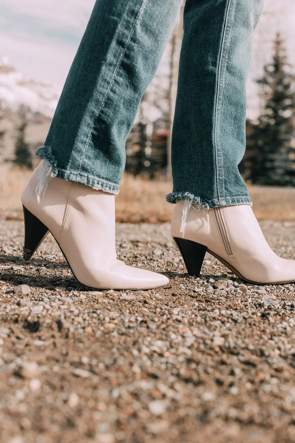 Bootie Trend, how to wear your ankle boots with dresses and jeans featuring white booties with a cone heel by Vince Camuto paired with a reversible faux fur coat, white turtleneck and Mother dazzler jeans