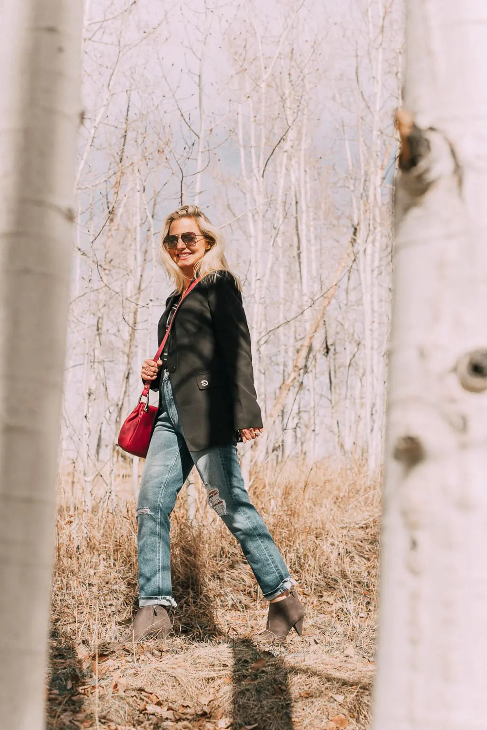 Bootie Trend, styling gray suede short ankle boots by Vince Camuto with Mother cropped jeans, rails black and white plaid shirt, black donna karen blazer and a red crossbody bag on fashion blogger Erin Busbee