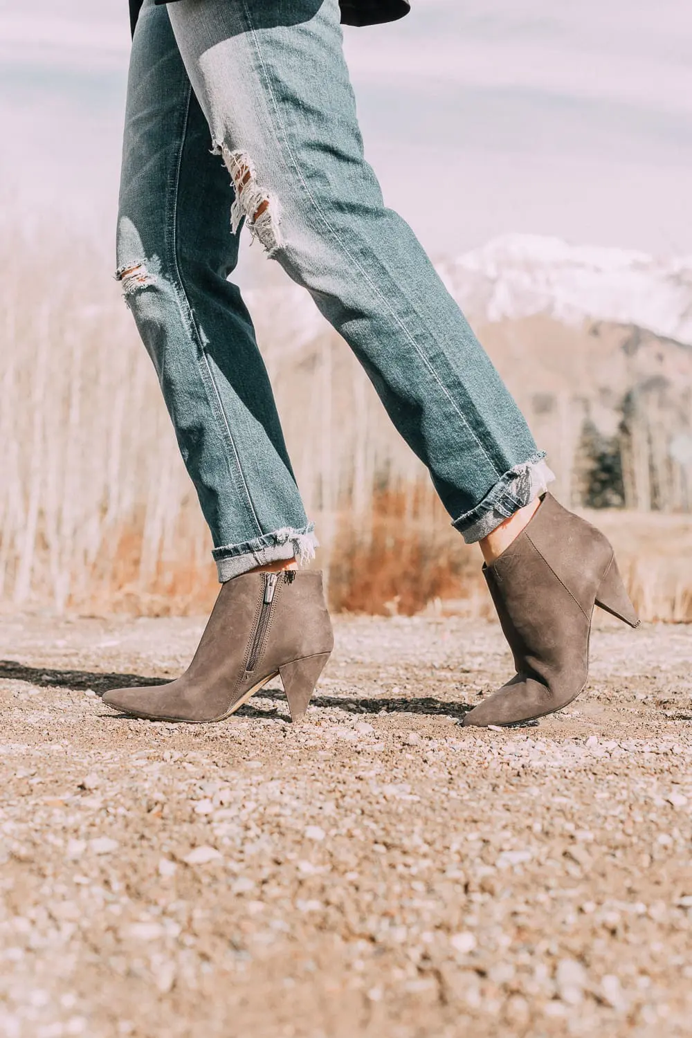 Bootie Trend, styling gray suede short ankle boots by Vince Camuto with Mother cropped jeans, rails black and white plaid shirt, black donna karen blazer and a red crossbody bag on fashion blogger Erin Busbee