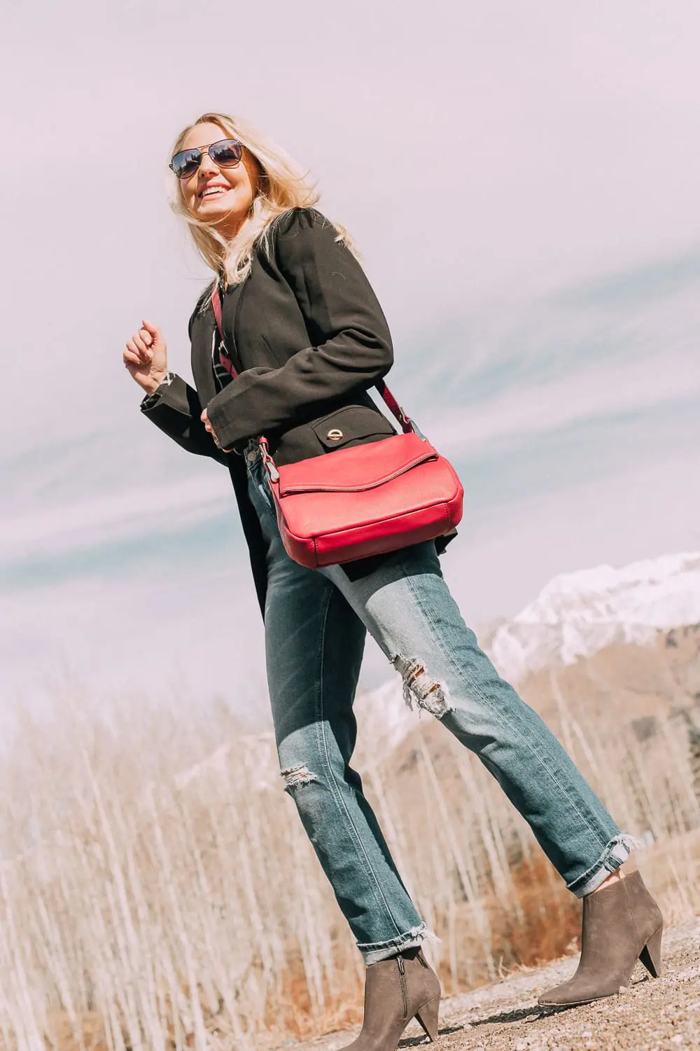 Bootie Trend, styling gray suede short ankle boots by Vince Camuto with Mother cropped jeans, rails black and white plaid shirt, black donna karen blazer and a red crossbody bag on fashion blogger Erin Busbee
