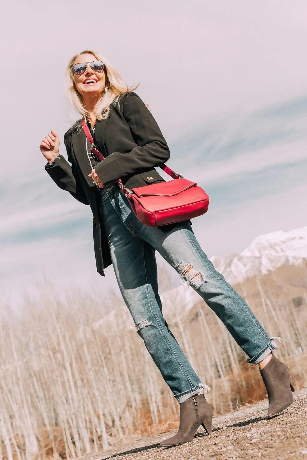 Bootie Trend, styling gray suede short ankle boots by Vince Camuto with Mother cropped jeans, rails black and white plaid shirt, black donna karen blazer and a red crossbody bag on fashion blogger Erin Busbee