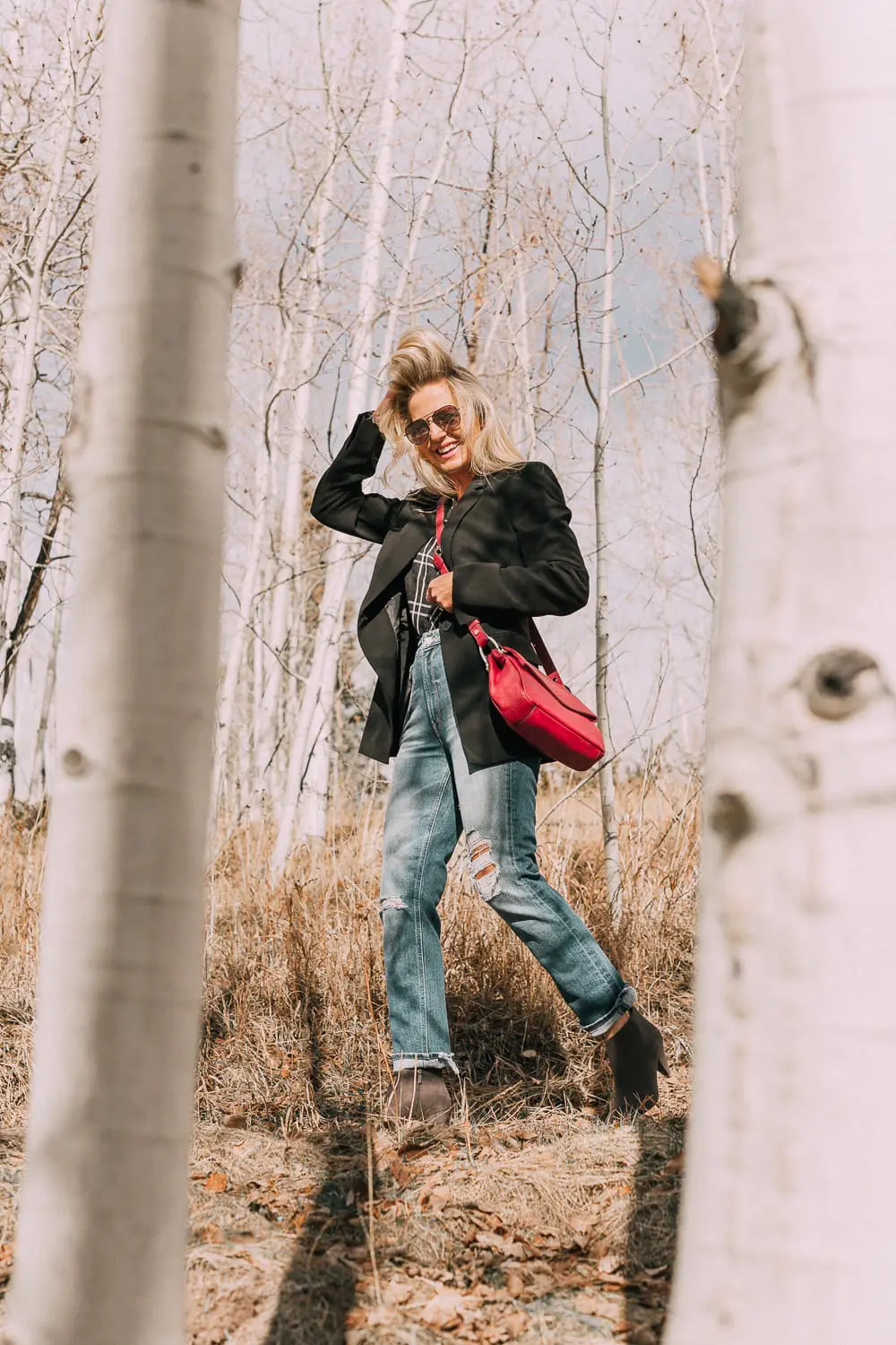 Bootie Trend, styling gray suede short ankle boots by Vince Camuto with Mother cropped jeans, rails black and white plaid shirt, black donna karen blazer and a red crossbody bag on fashion blogger Erin Busbee