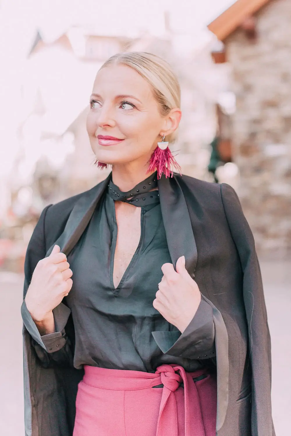 What to wear to a holiday party when it's cold outside, featuring a burgundy pencil skirt, black silky tie neck blouse, black diamond print tights, crystal studded ankle booties, and a black tuxedo blazer from Express 