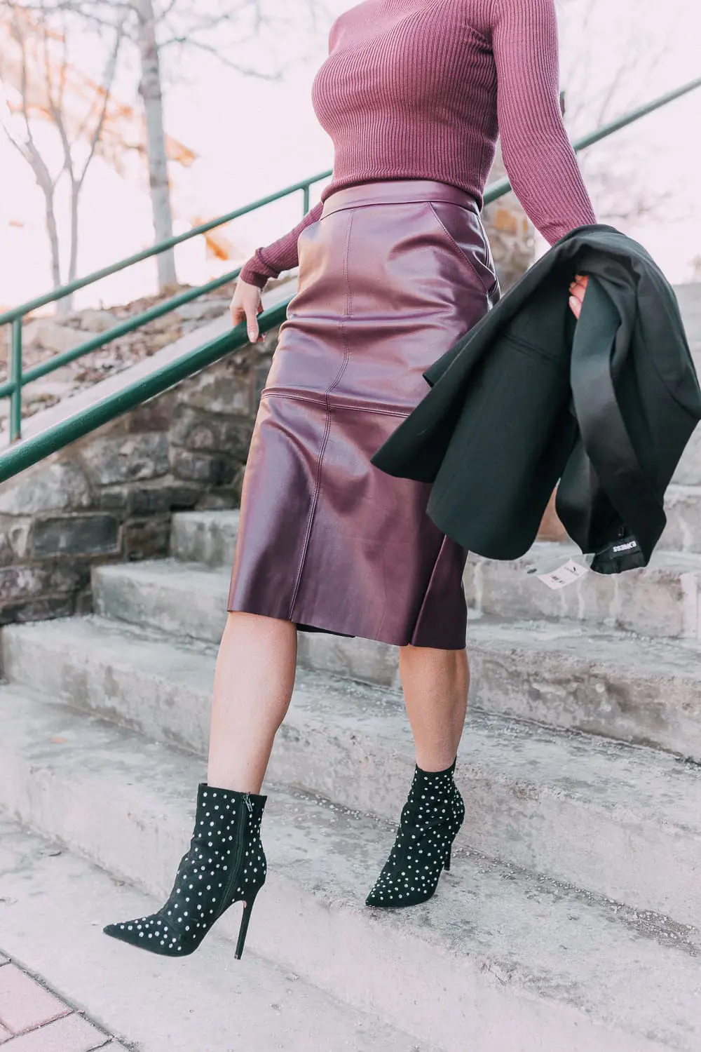 What to wear to a holday party when it's cold featuring a faux leather burgundy pencil skirt, ribbed burgundy turtleneck sweater, paired with a black tuxedo blazer and studded stiletto black booties from Express