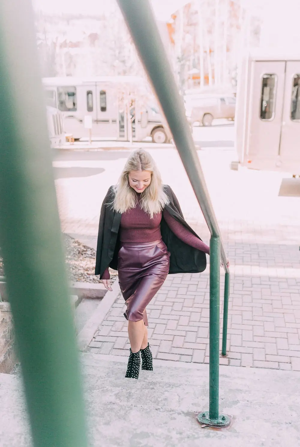 What to wear to a holday party when it's cold featuring a faux leather burgundy pencil skirt, ribbed burgundy turtleneck sweater, paired with a black tuxedo blazer and studded stiletto black booties from Express