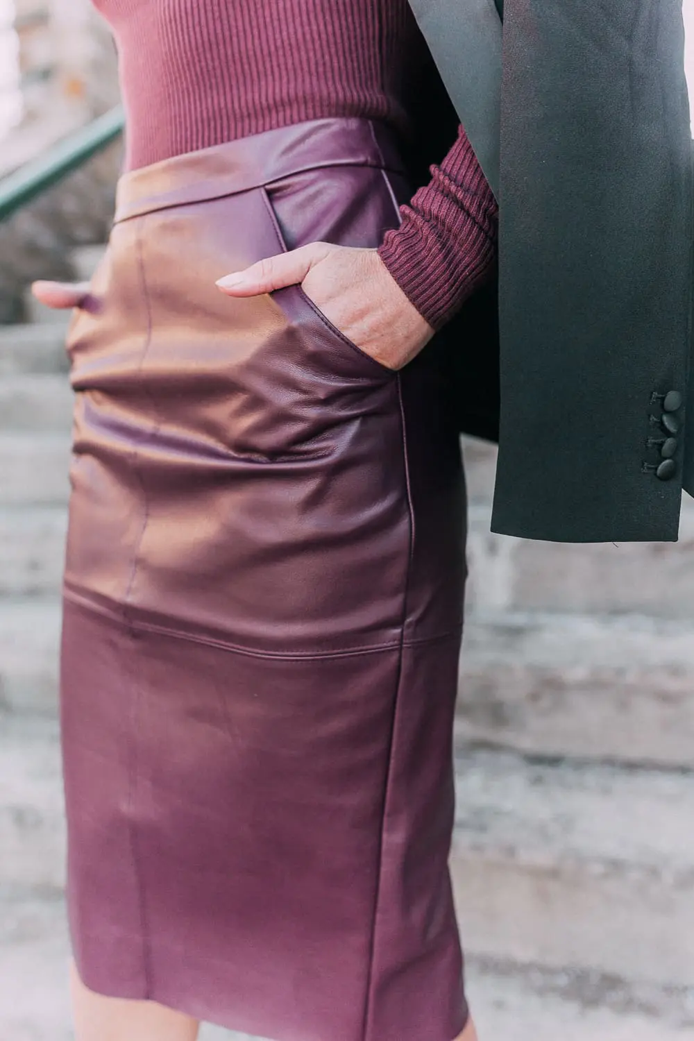 What to wear to a holday party when it's cold featuring a faux leather burgundy pencil skirt, ribbed burgundy turtleneck sweater, paired with a black tuxedo blazer and studded stiletto black booties from Express