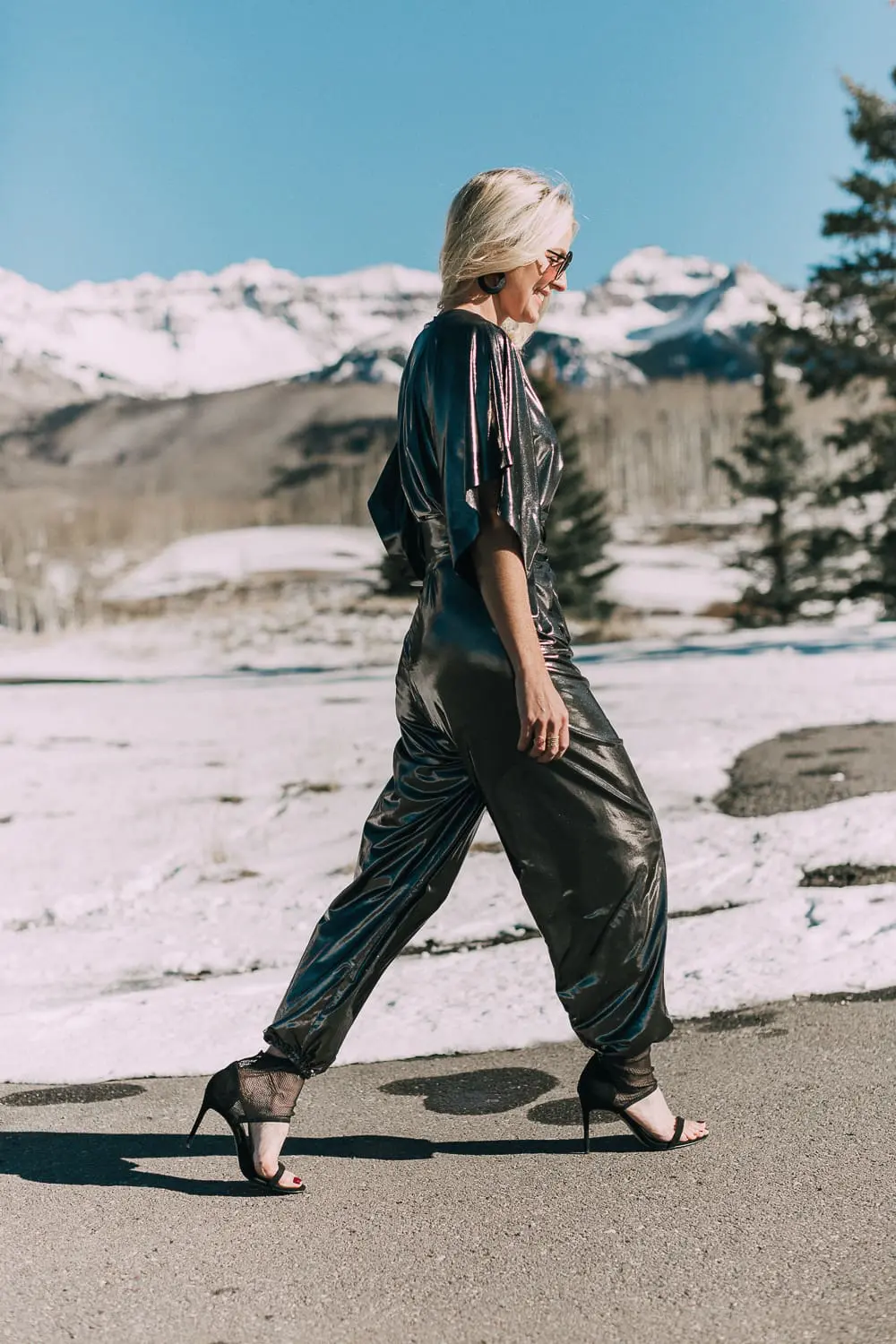 New Year's Eve Outfit Ideas featuring a metallic jumpsuit by Norma Kamali with black heels on Fashion Blogger Erin Busbee of Busbee Style, fashion over 40
