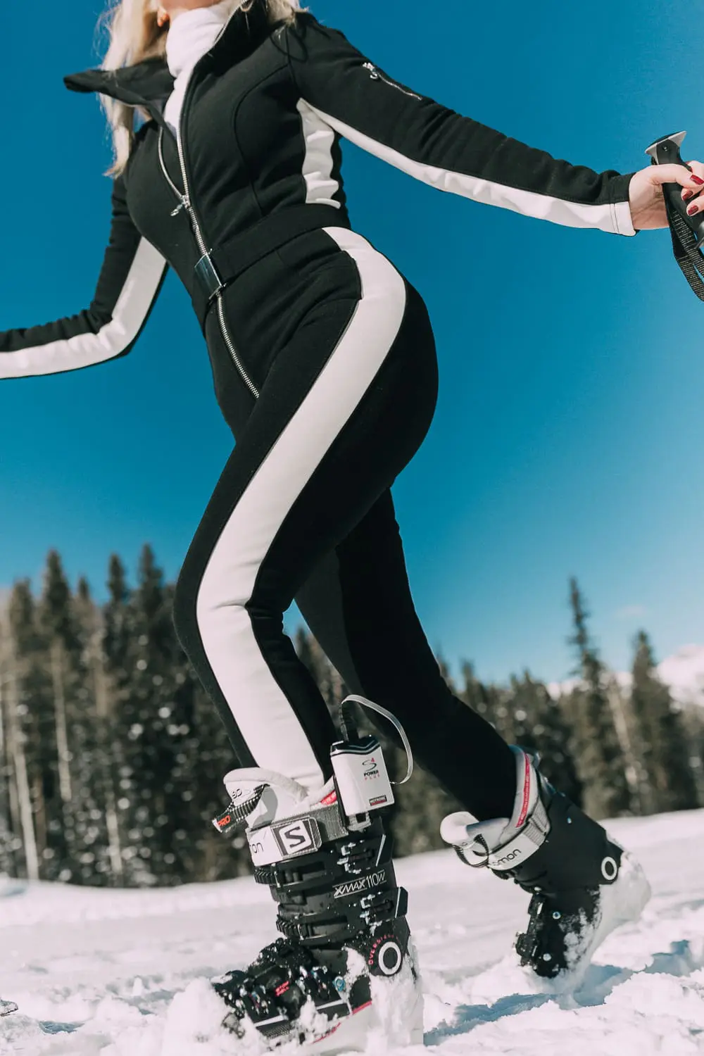Ski Gear for women on eBay featuring a one-piece ski suit jumpsuit by Cordova on fashion blogger with blonde hair in snowy mountains, fashion blogger over 40 Erin Busbee of Busbeestyle.com