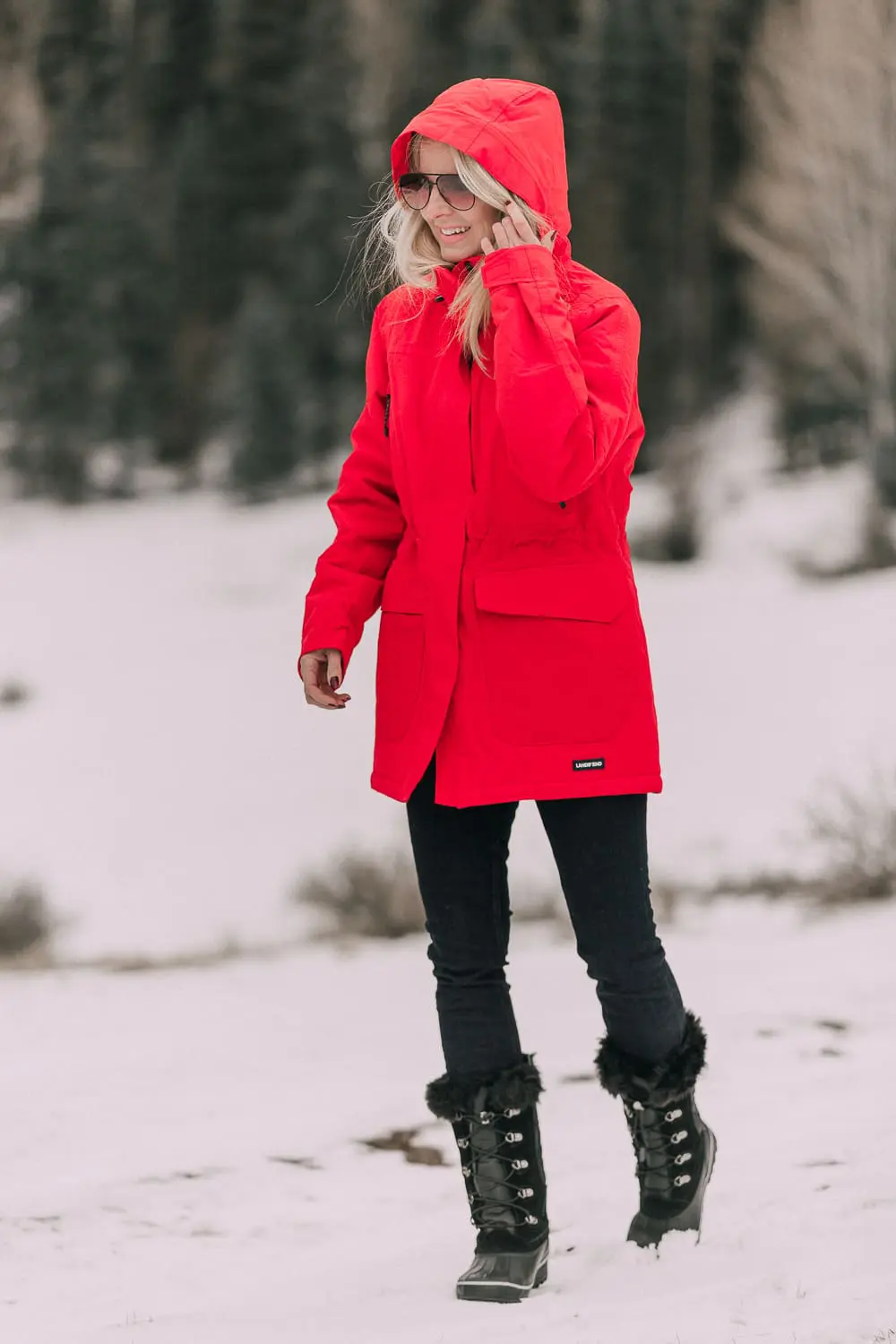Fashion Blogger Erin Busbee of BusbeeStyle.com wearing a Land's End red parka with Sorel snow boots and jeans