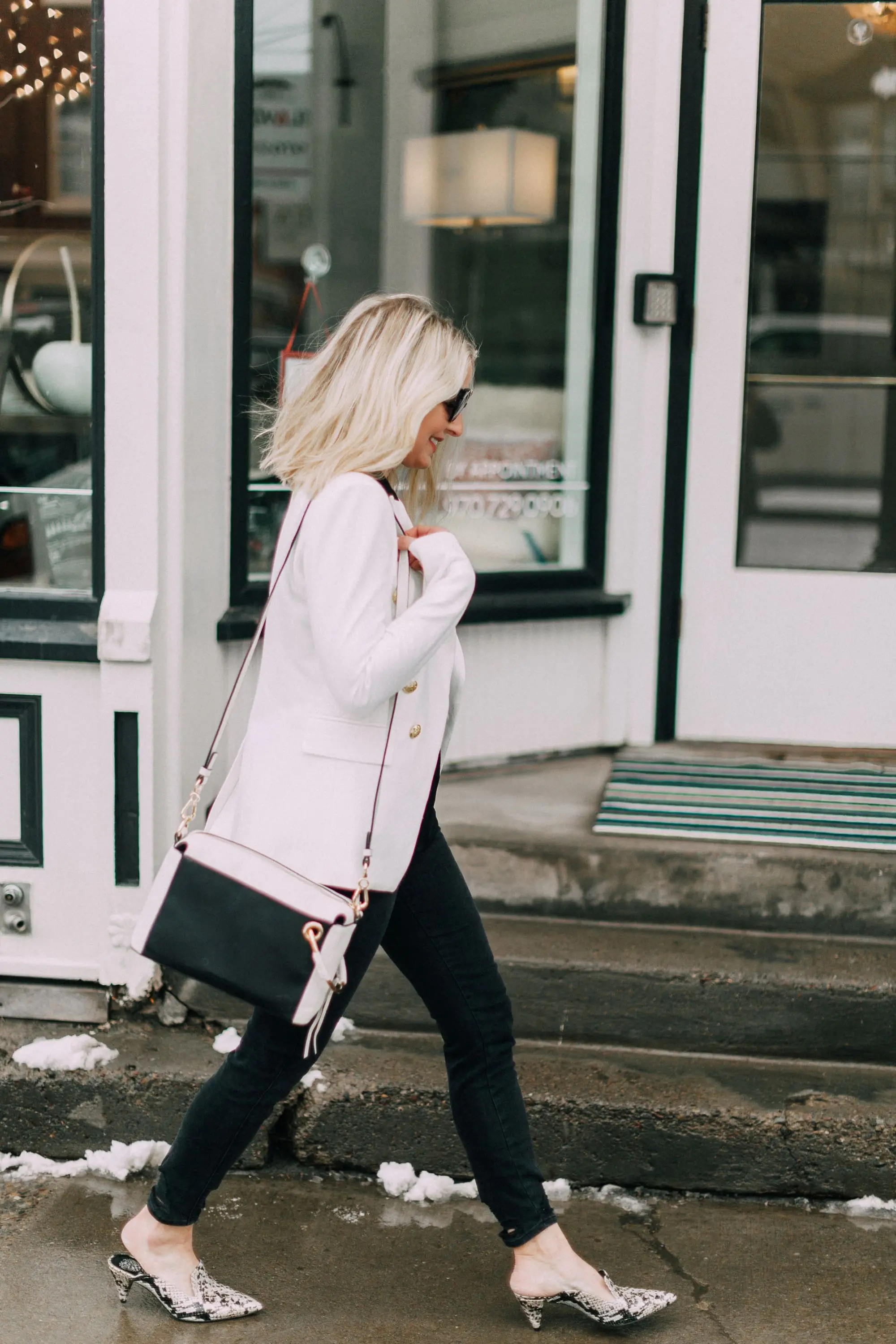 blond fashion blogger wearing python Cessilia Vince Camuto mules black jeans white blazer white Margi shoulder bag
