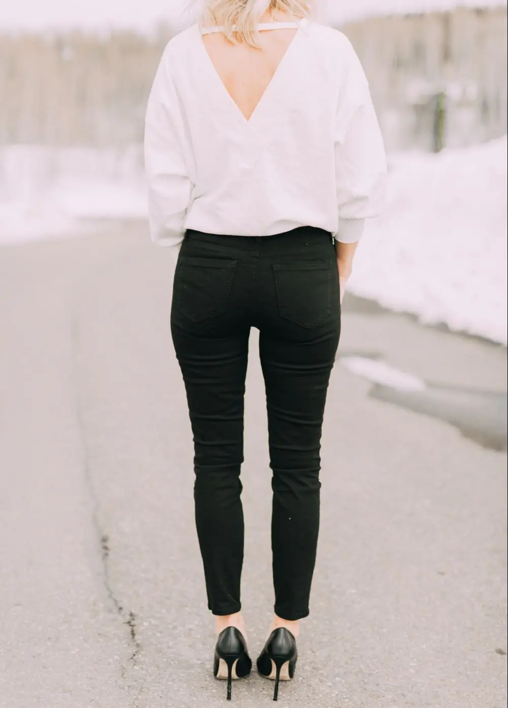 slimming affordable jeans by sofia vergara for walmart in a stylish outfit with black high heel pumps and white top from behind