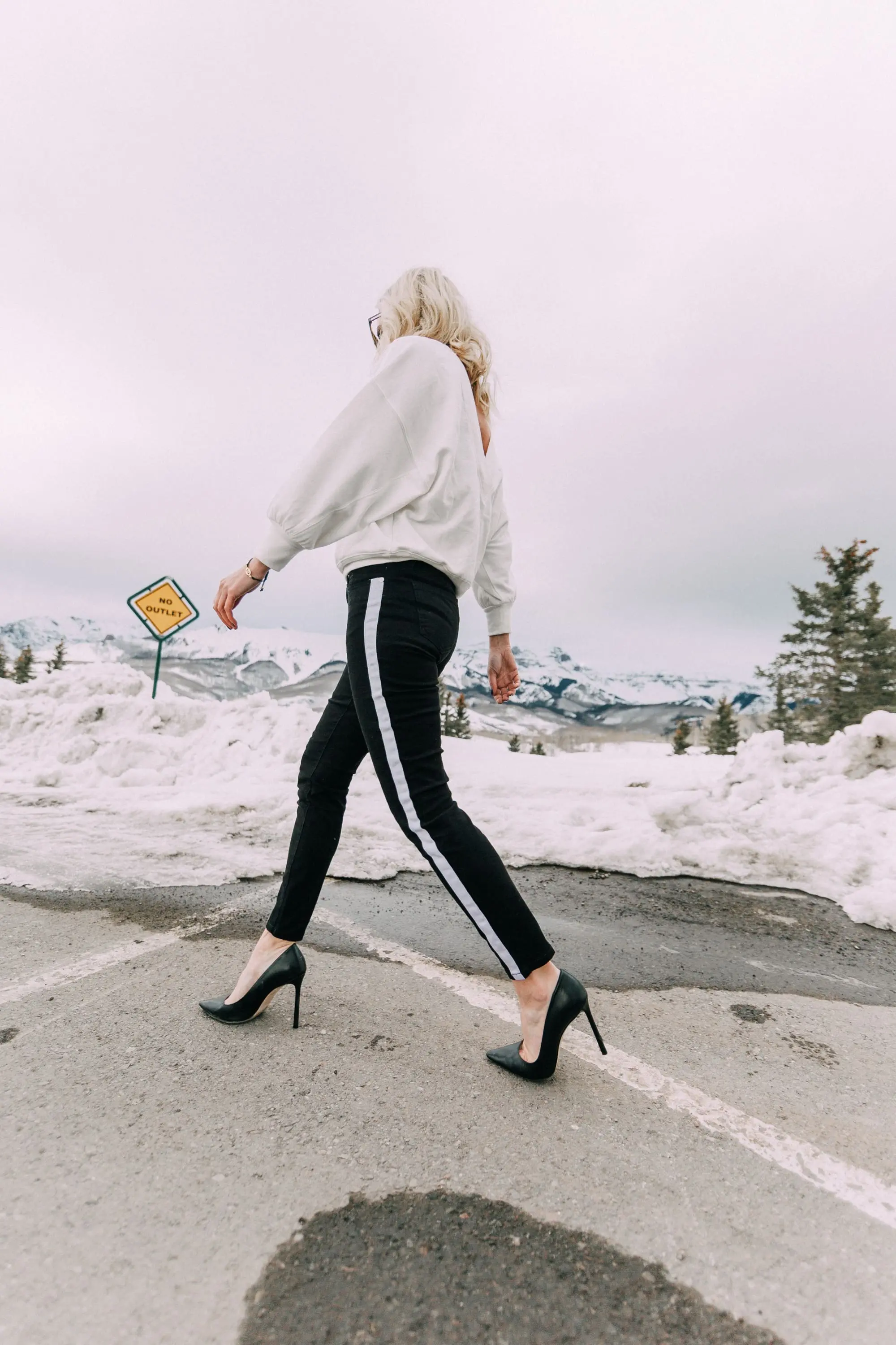 Slimming Affordable Jeans, Fashion blogger Erin Busbee of BusbeeStyle.com wearing a white open back sweatshirt and black side stripe jeans by Sofia Vergara from Walmart in Telluride, CO