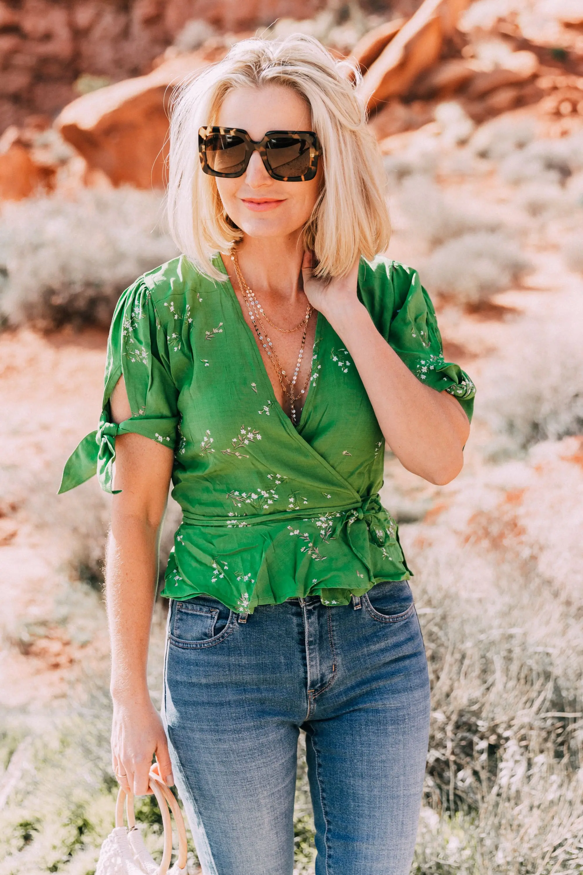 fashion blogger wearing faithfull the brand green lucy wrap top and levi's 721 skinny blue jeans