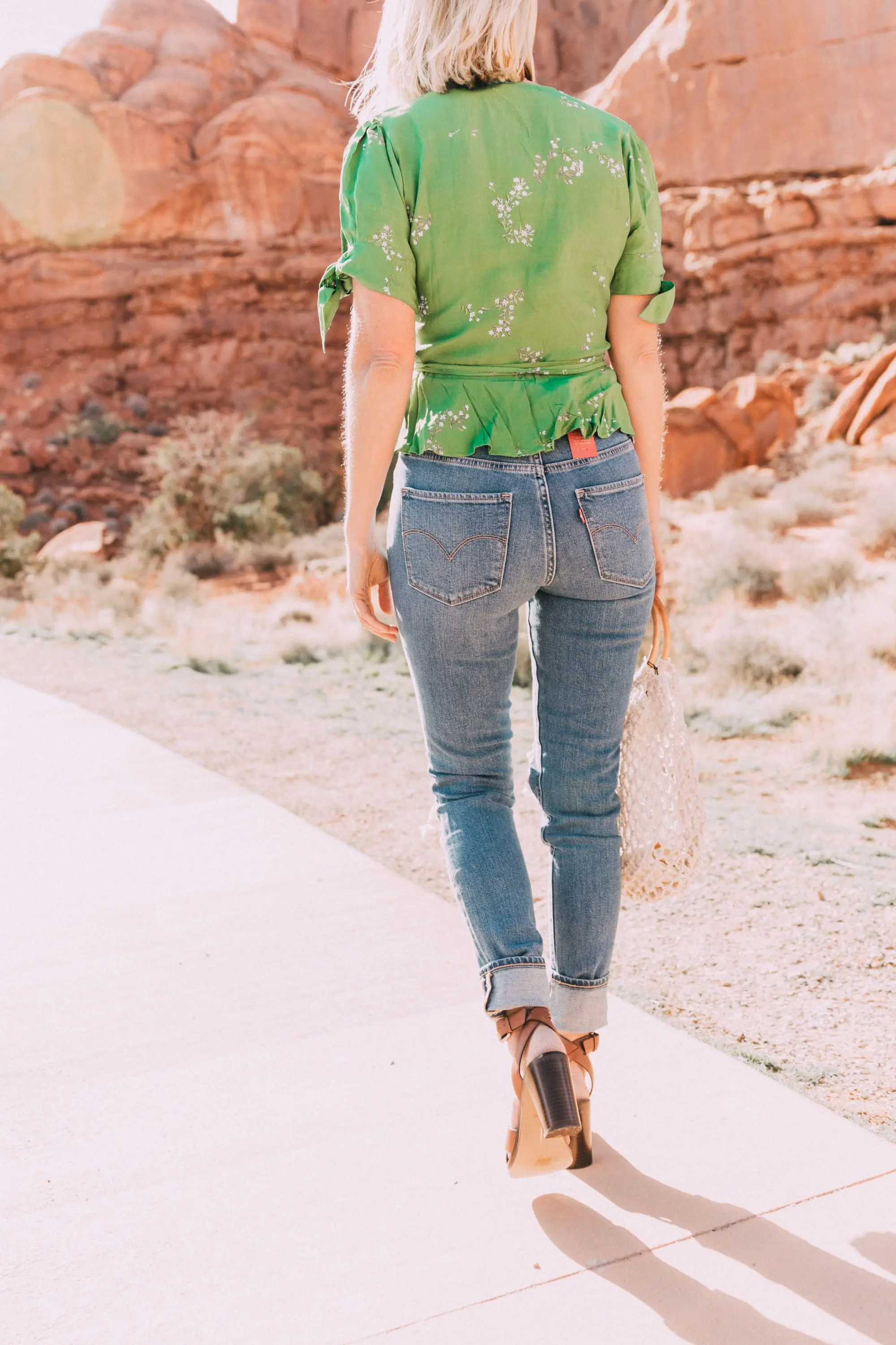 Good For The Globe, Fashion blogger Erin Busbee of BusbeeStyle.com featuring Levi 721 skinny jeans, a green floral Faithfull The Brand top, Kayu rope bag from Bloomingdale's in Moab, Utah