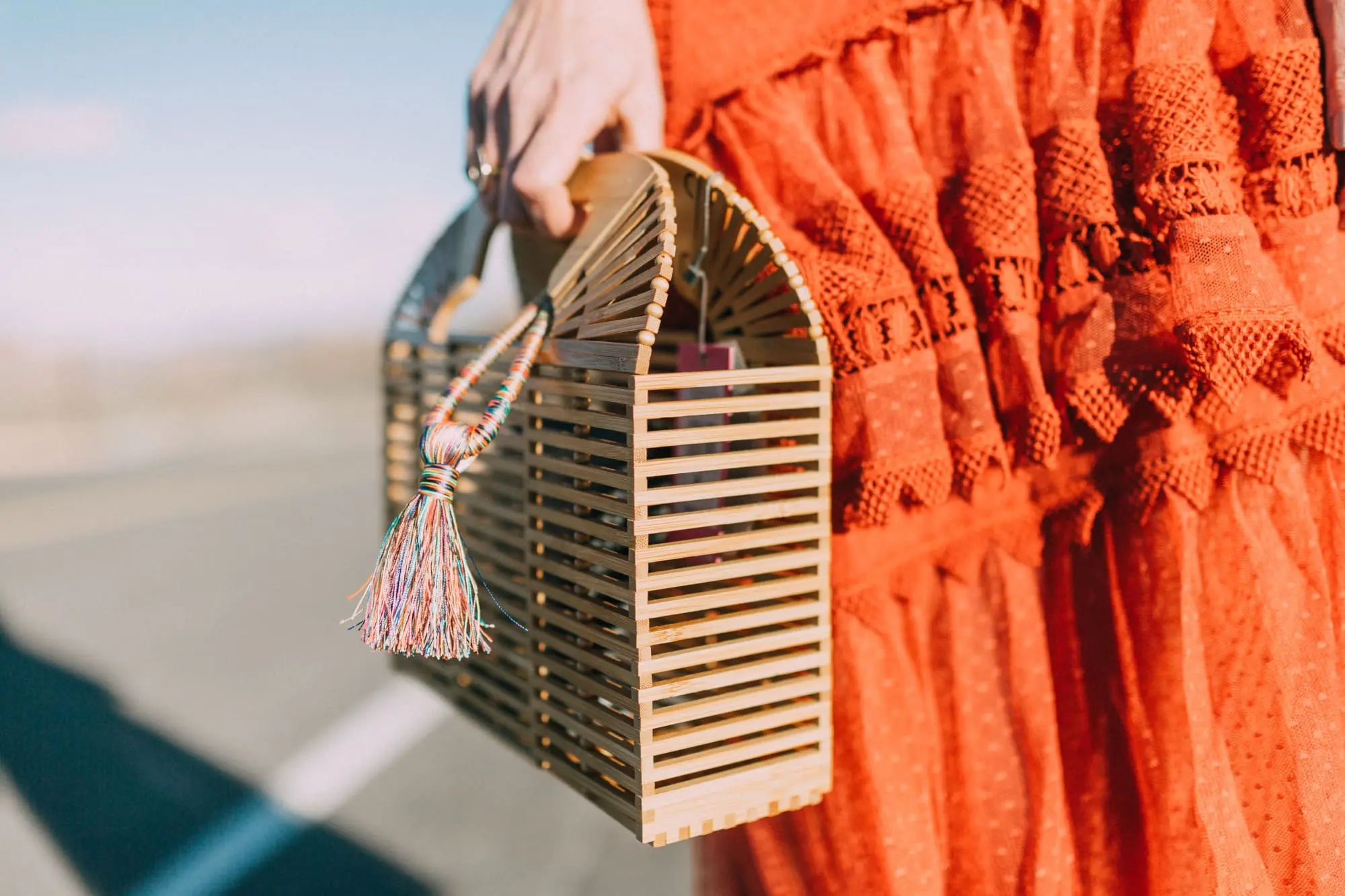 Spring Handbags, Fashion blogger Erin Busbee of BusbeeStyle.com wearing an ornage House of Harlow dress from Revolve with Vince Camuto bamboo basket bag in Moab, Utah