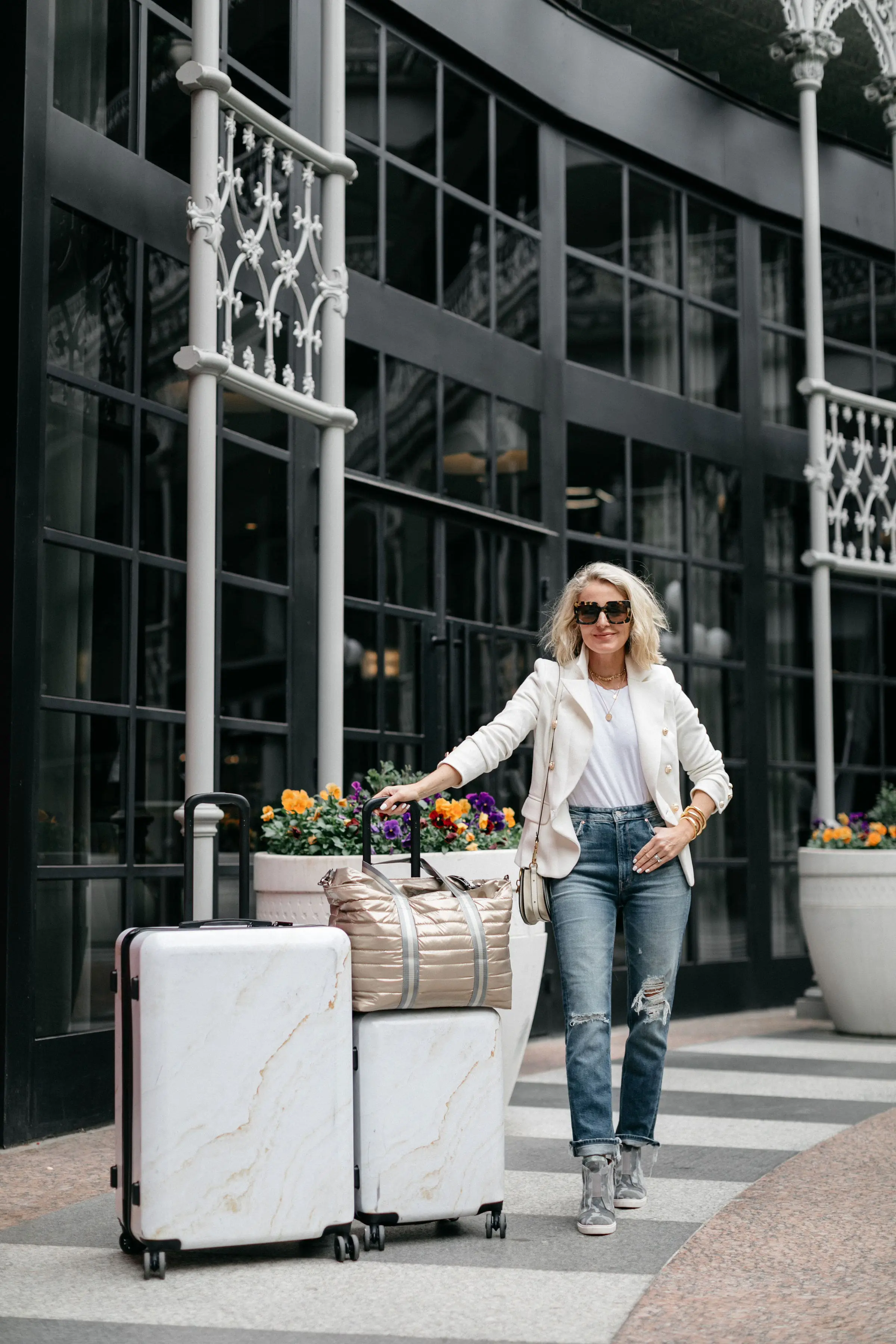 reward style Conference 2019, Fashion blogger Erin Busbee of BusbeeStyle.com wearing jeans, camo sneakers, and a white blazer in Dallas, Texas