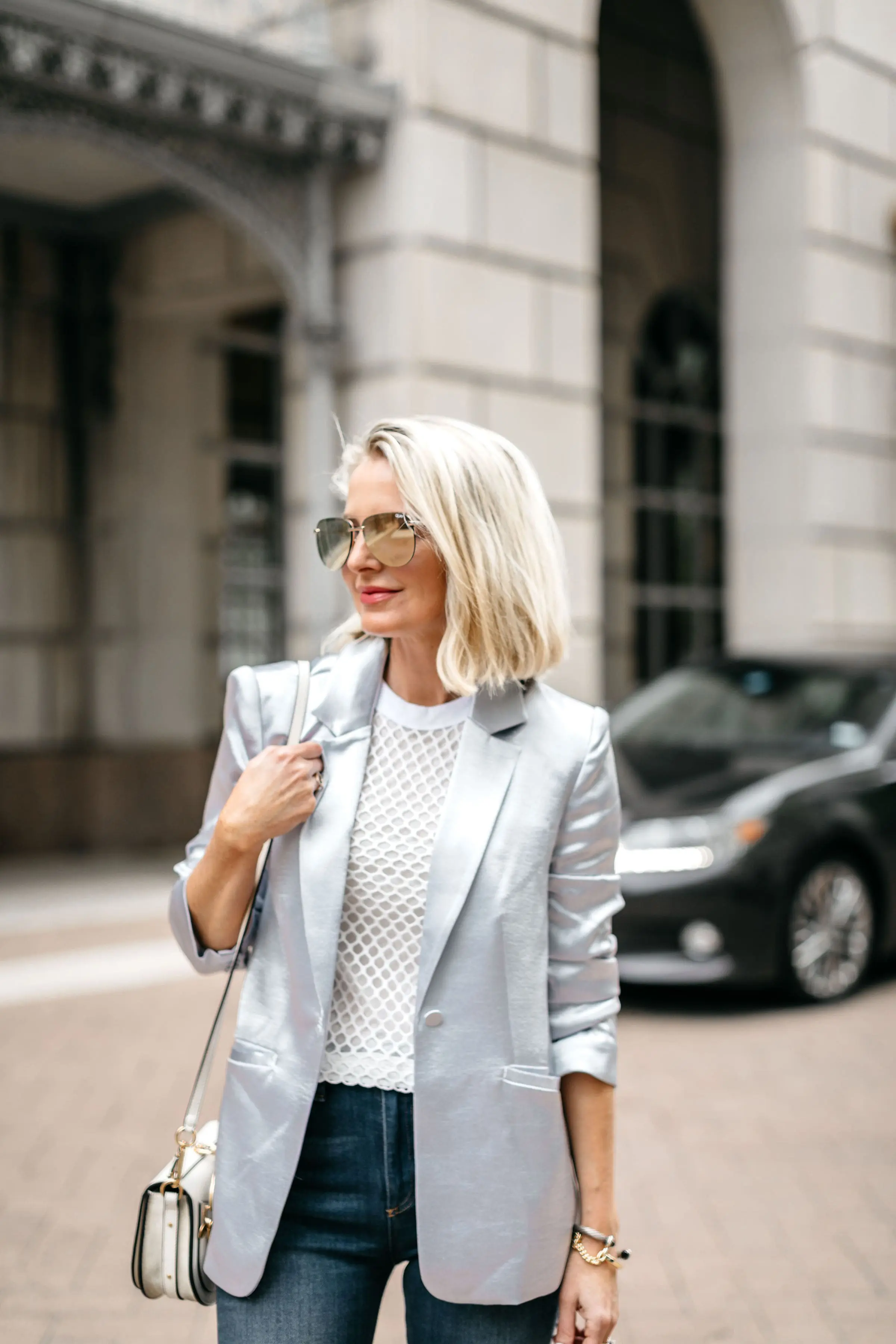 Reward Style Conference 2019, Fashion Blogger Erin Busbee of BusbeeStyle.com wearing Mother jeans, a metallic shiny blazer, and fishnet tee in Dallas, Texas