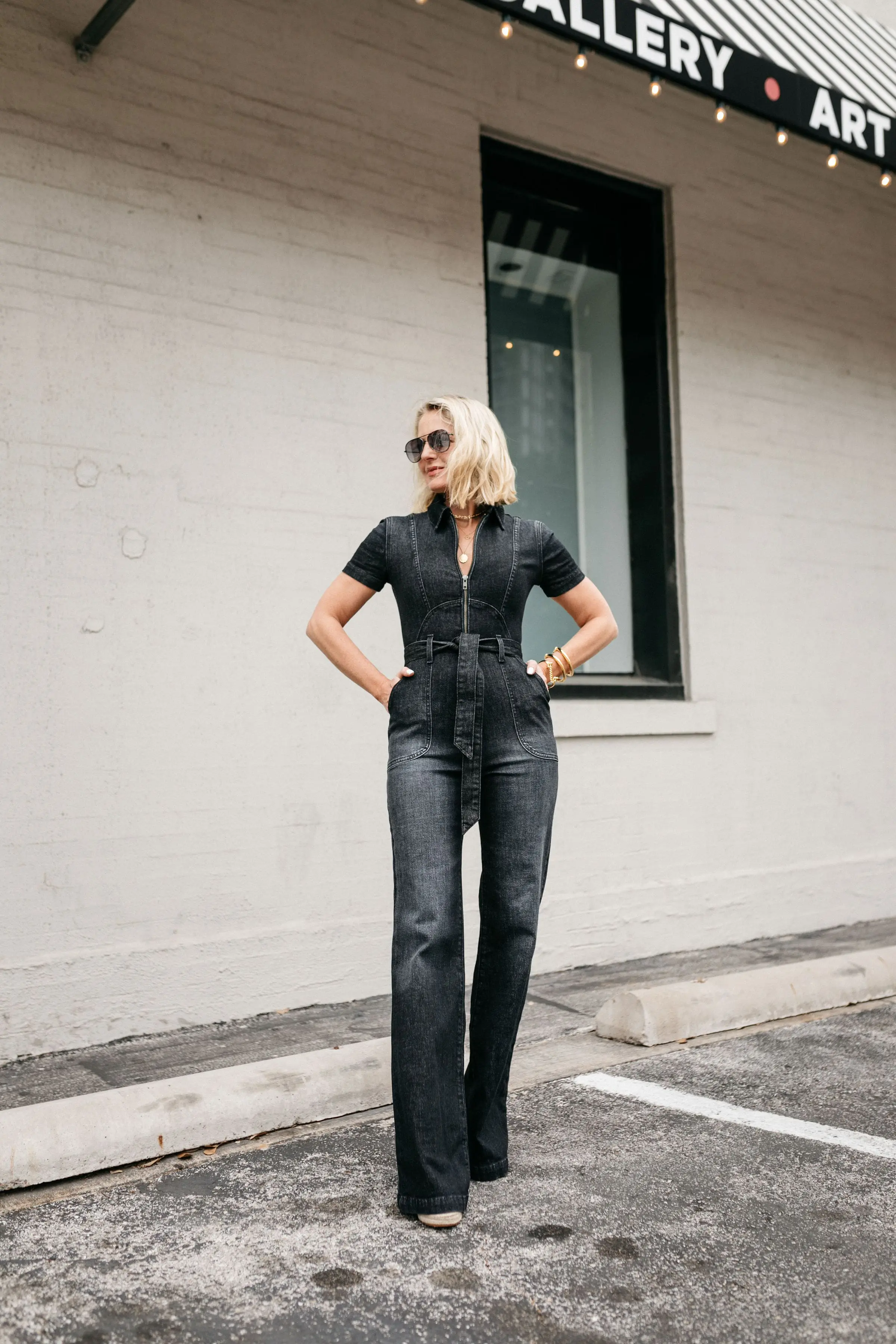 Reward Style Conference 2019, Fashion Blogger Erin Busbee of BusbeeStyle.com wearing an Alice + Olivia black denim jumpsuit in Dallas, Texas
