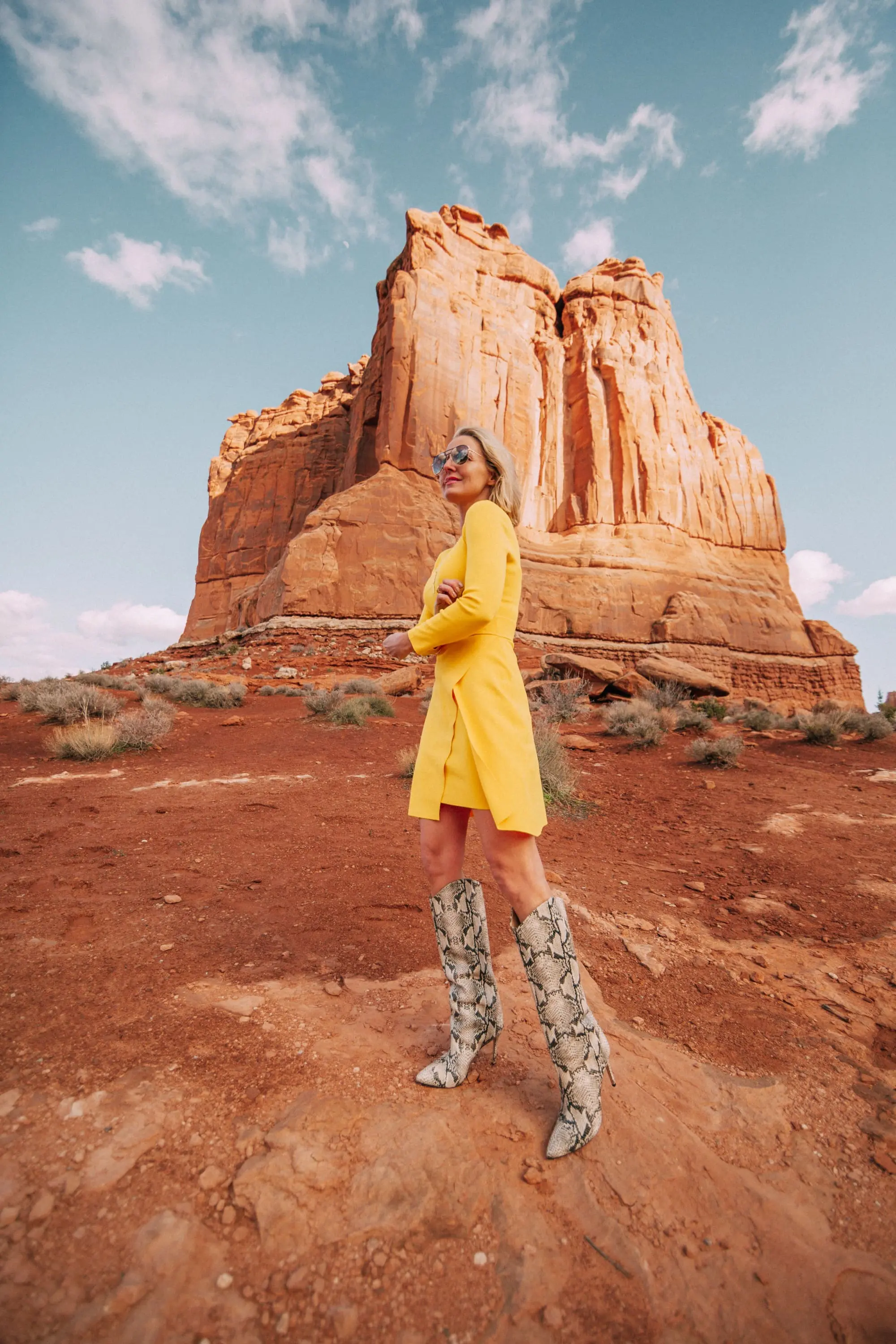 What To Wear To A Spring Wedding, Fashion blogger Erin Busbee of BusbeeStyle.com wearing a yellow long sleeve mini dress by ALC and Schultz python print boots in Moab, Utah