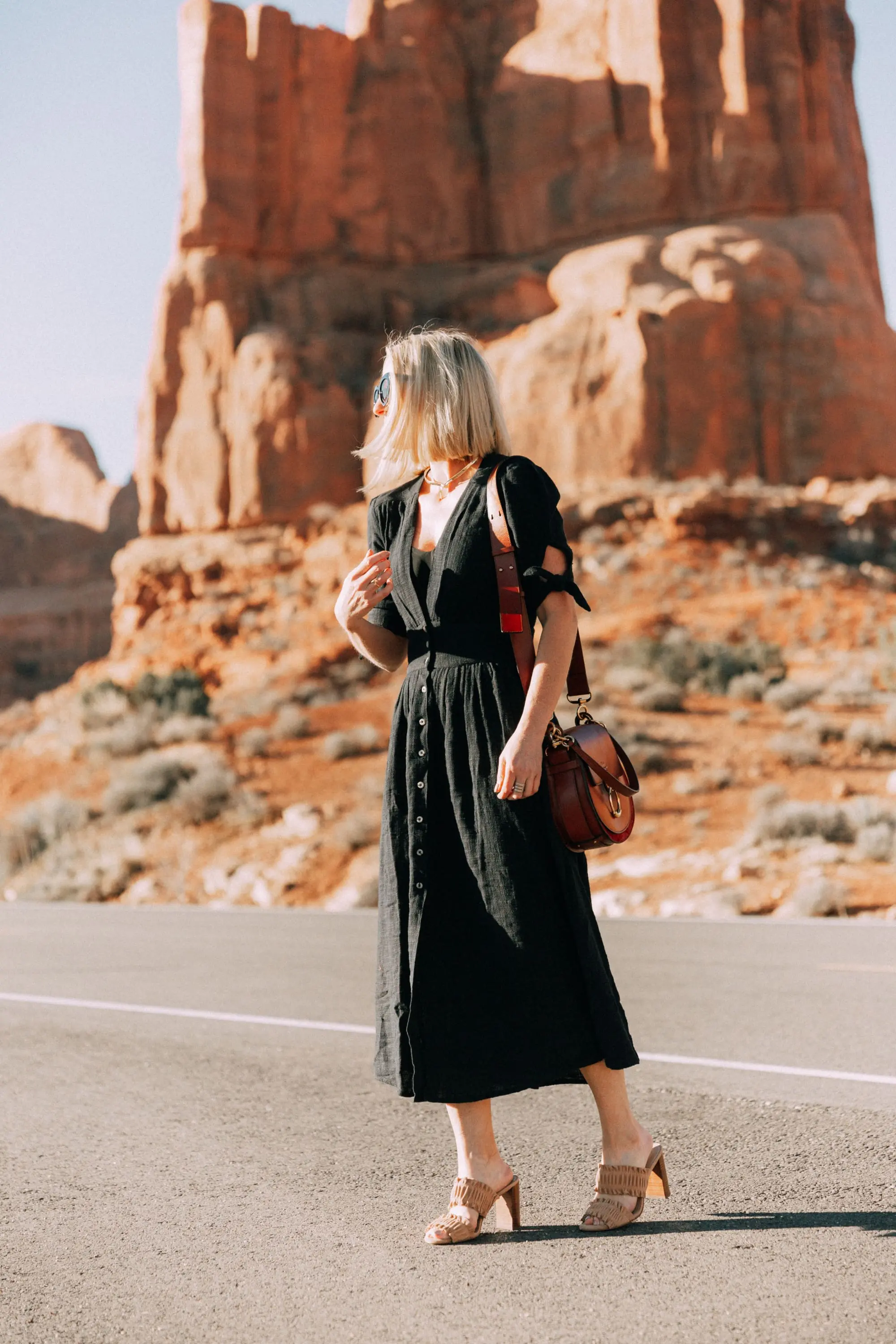 Spring Dresses, Fashion blogger Erin Busbee of BusbeeStyle.com wearing a black Free People button front dress, with Ann Taylor sandals and the CHloe Tess handbag in Moab, Utah