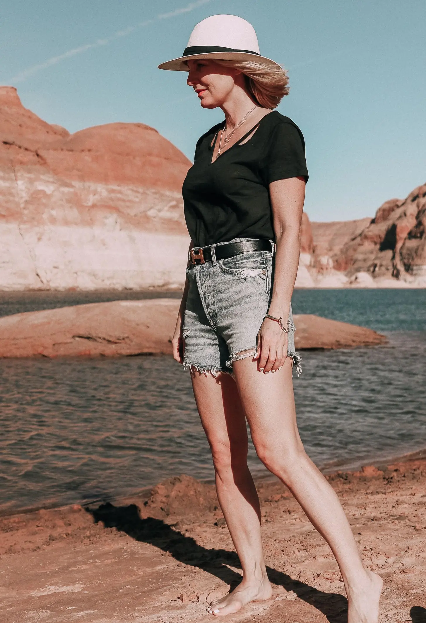 Age Appropriate Denim Shorts, Fashion blogger over 40 Erin Busbee of BusbeeStyle.com wearing AGOLDE denim shorts and a black tee with white Superga sneakers at Lake Powell