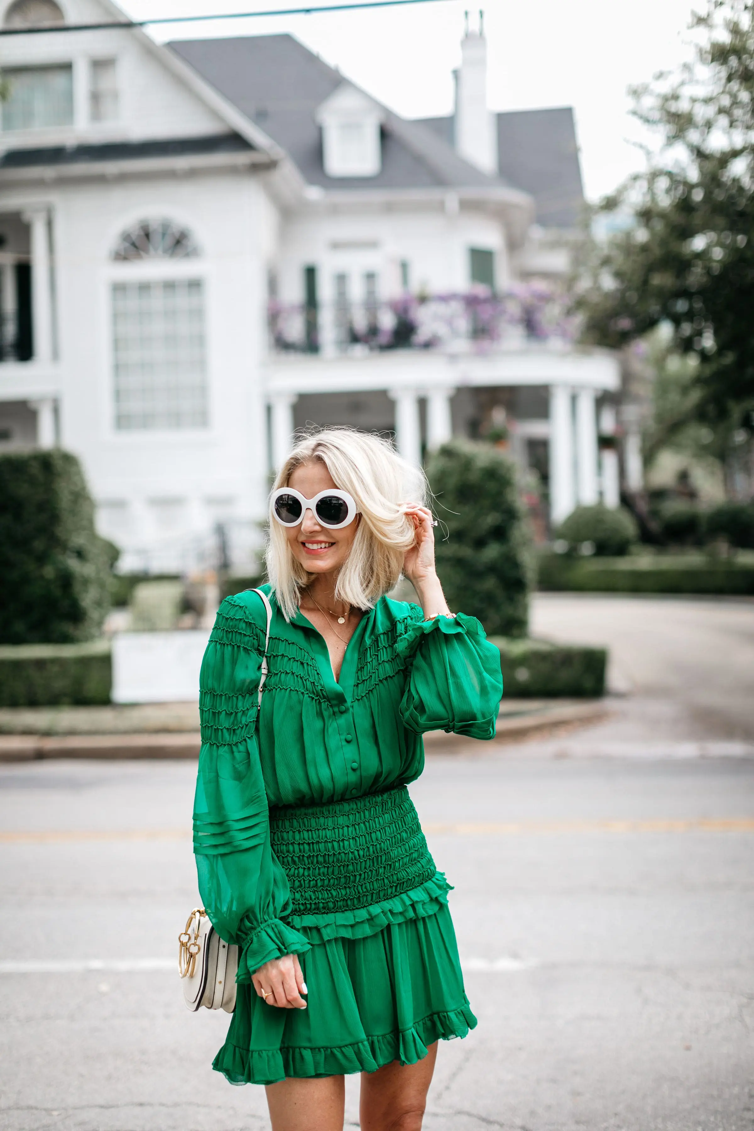 fashion blogger wearing silk green ruffle dress carrying chloe nile small bracelet crossbody bag in dallas texas
