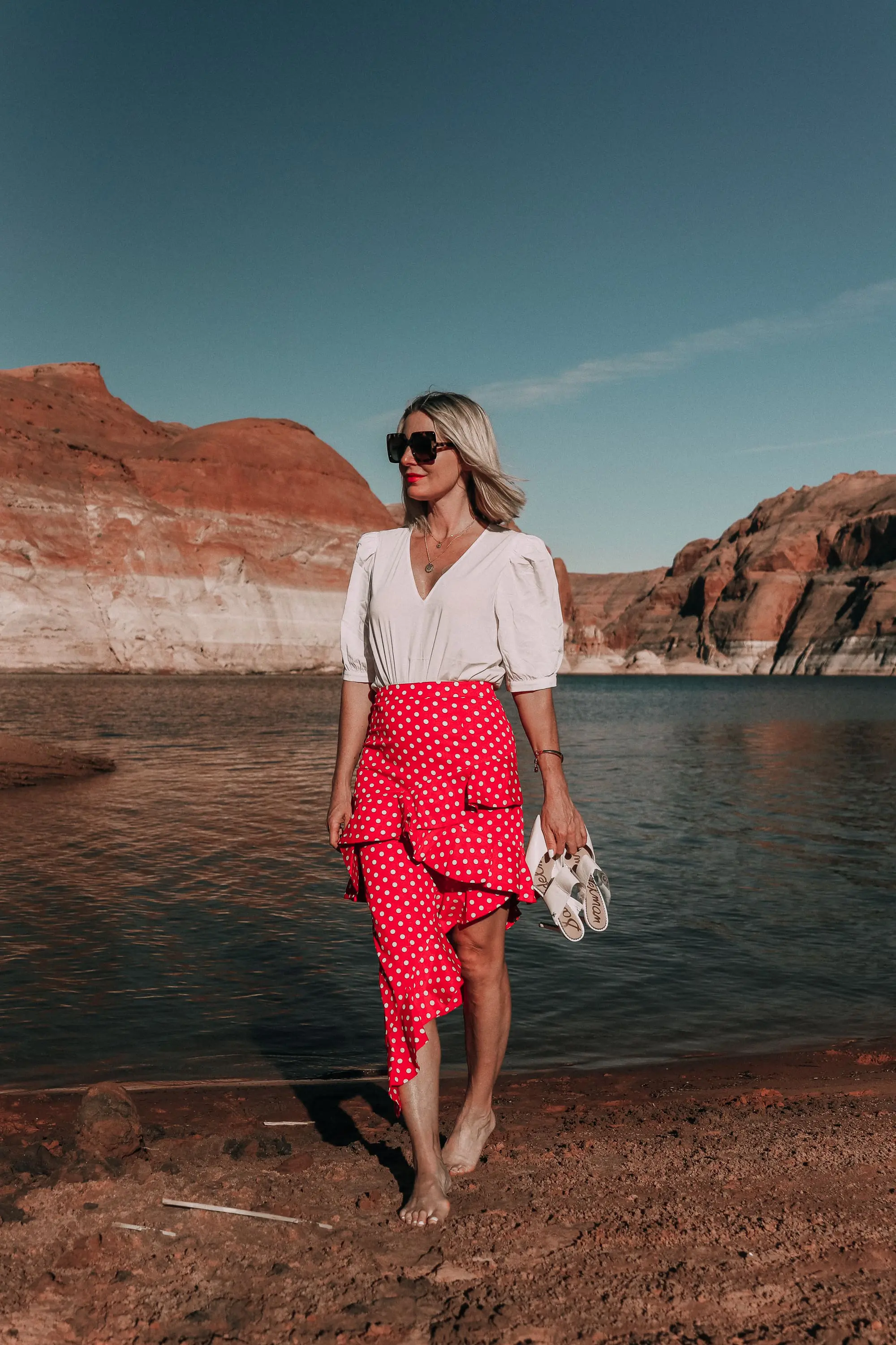 Polka Dots, Fashion blogger Erin Busbee of BusbeeStyle.com featuring a polka dot skirt by Majorelle from Revolve, a white Something Navy bodysuit, and Sam Edelman white pumps at Lake Powell
