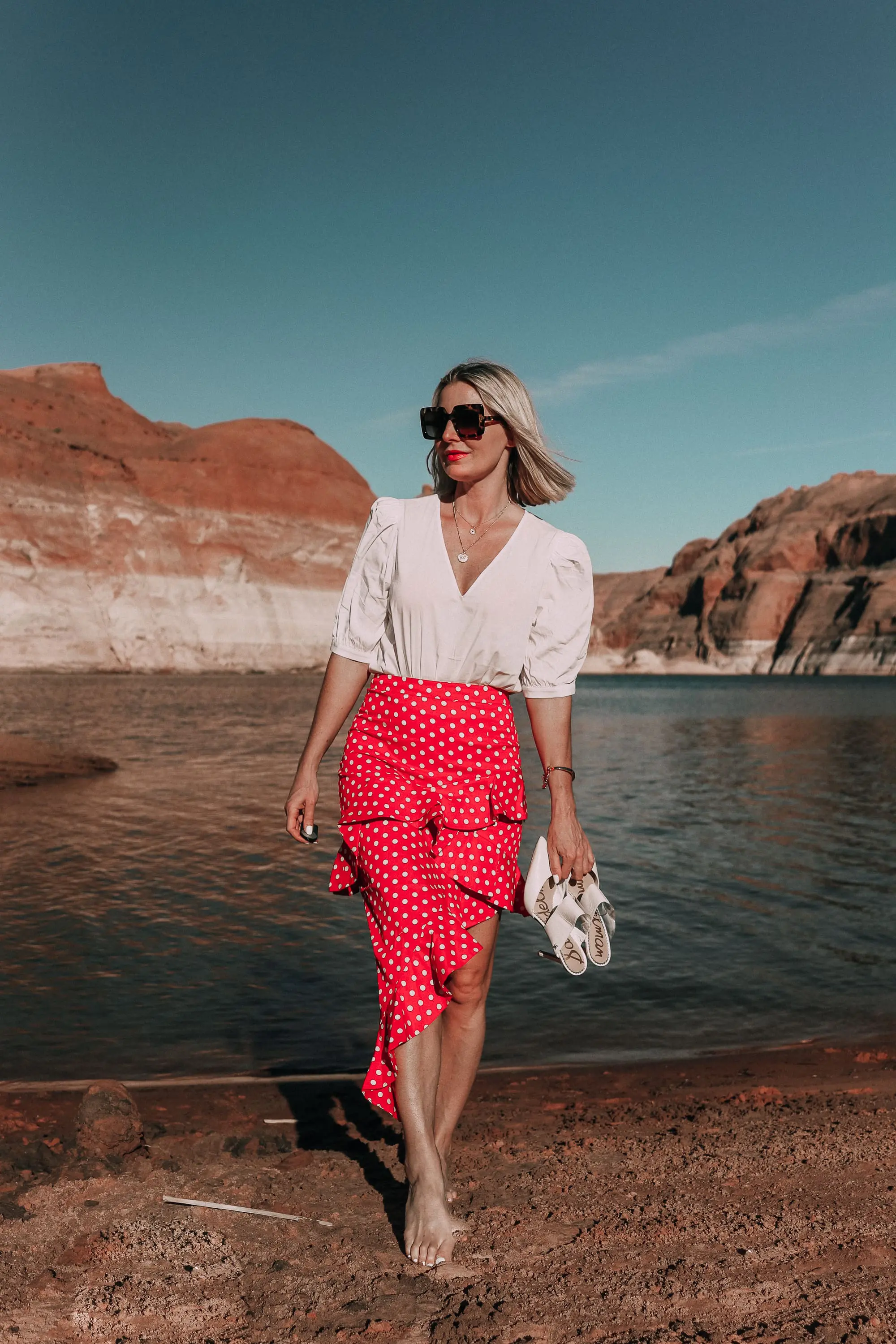 fashion blogger wearing red majorella polka dot ruffle skirt with something navy fitted puff shoulder bodysuit