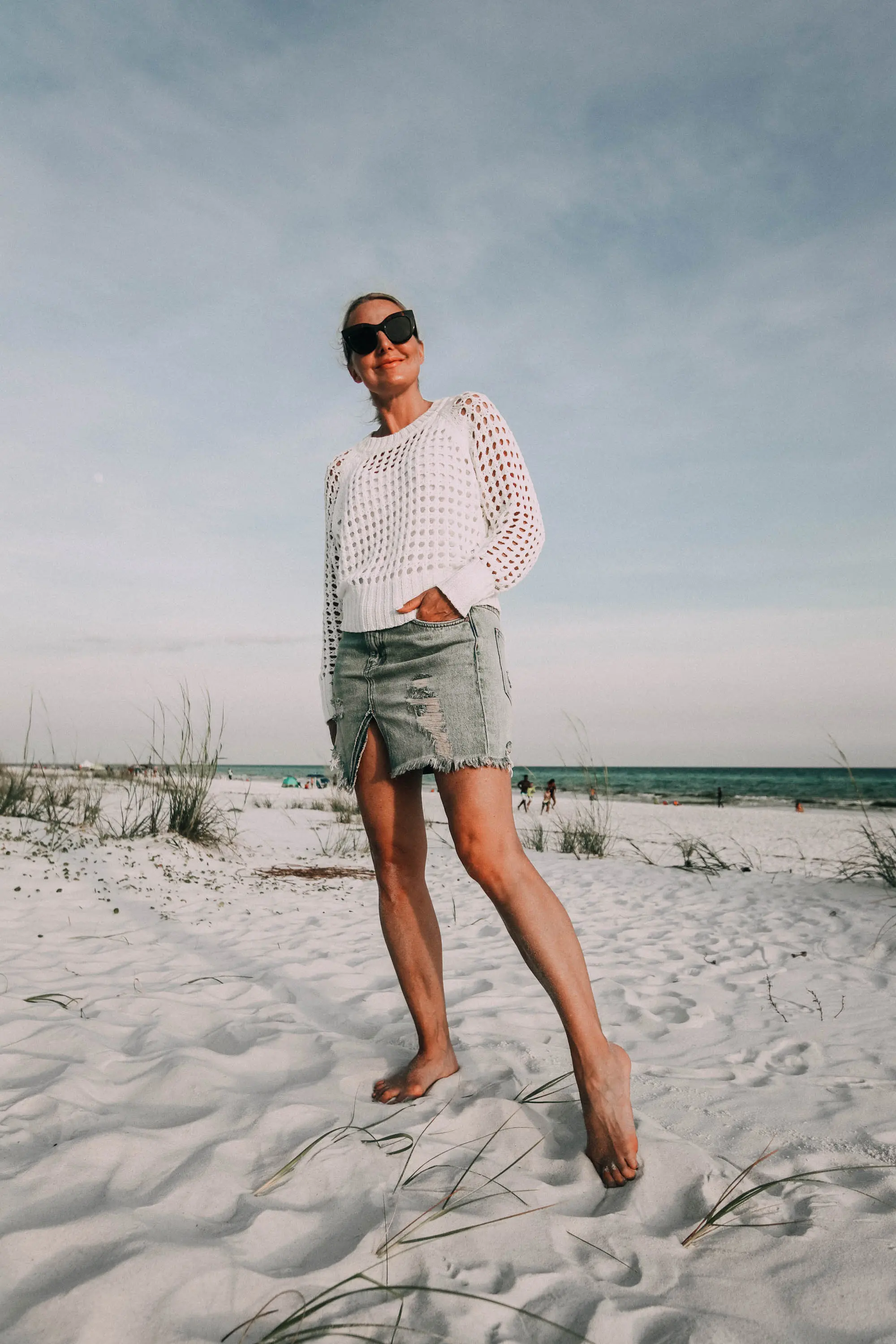 Denim Skirts, Fashion blogger Erin Busbee of BusbeeStyle.com wearing a denim skirt by Free People with a white knit sweater from Nordstrom on the beach in Florida